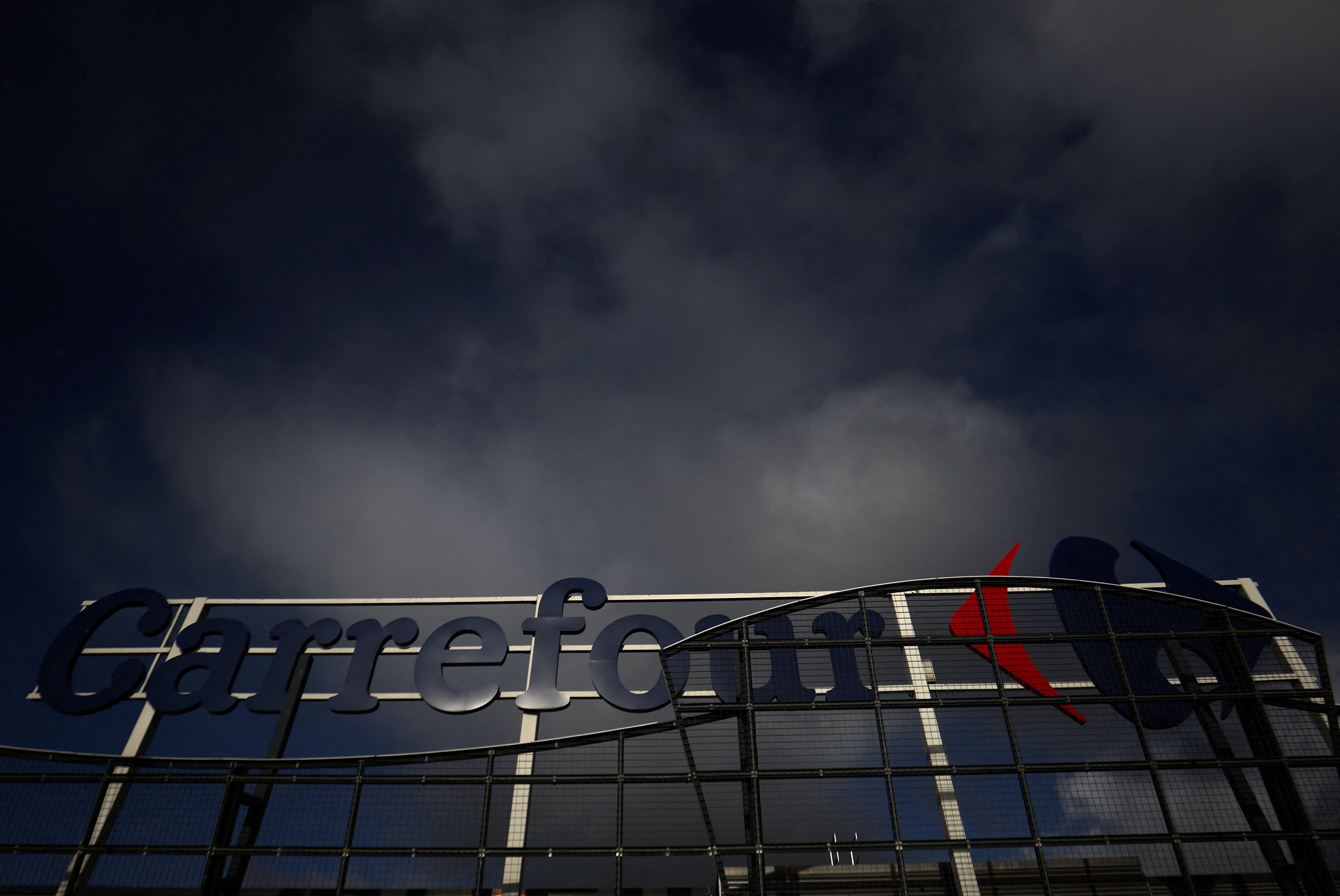 The logo of Carrefour sits atop on the roof of a shopping center in Drogenbos near Brussels