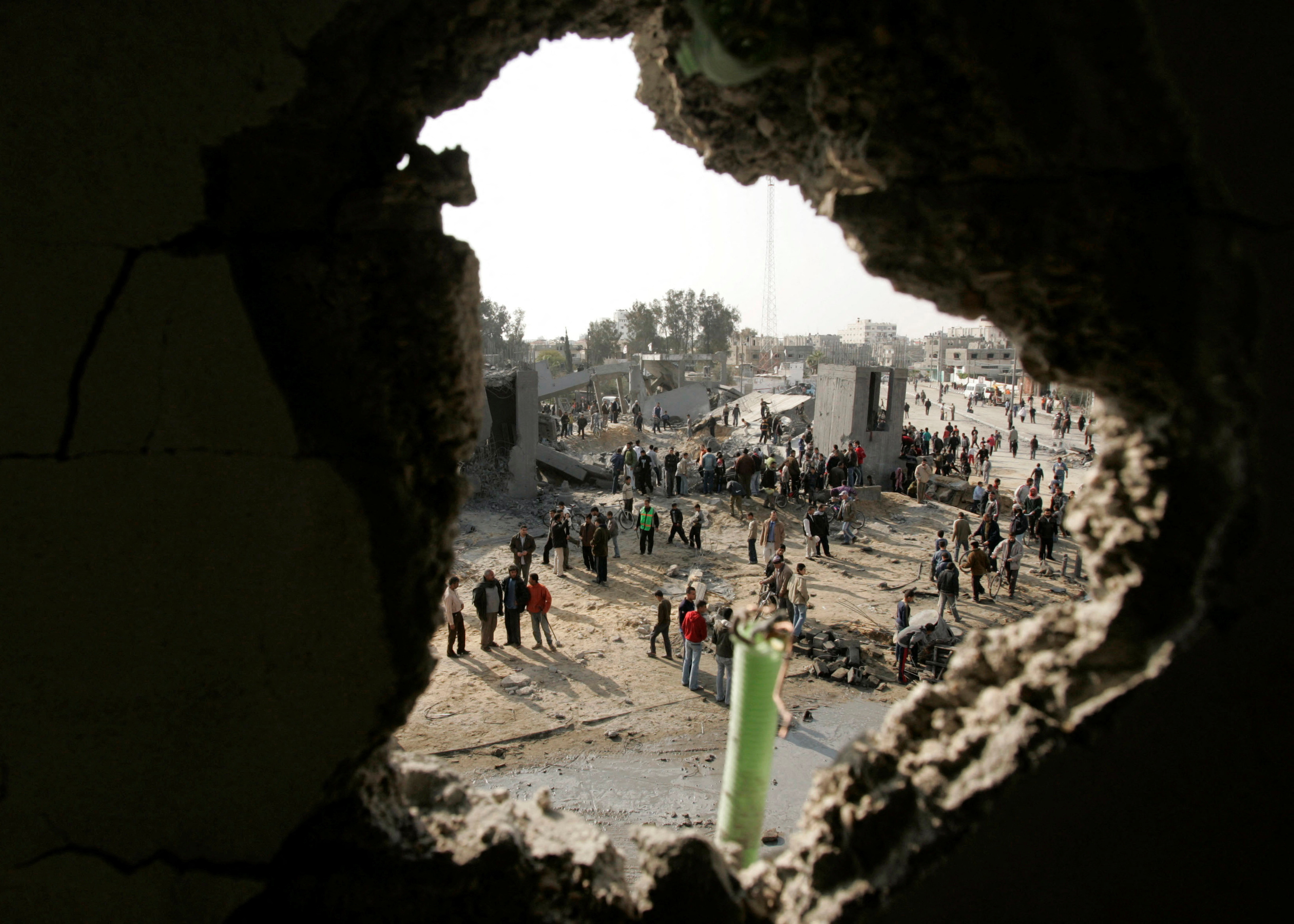 Palestinians inspect Badr mosque after it was bombed by Israeli military aircraft in the southern Gaza Strip