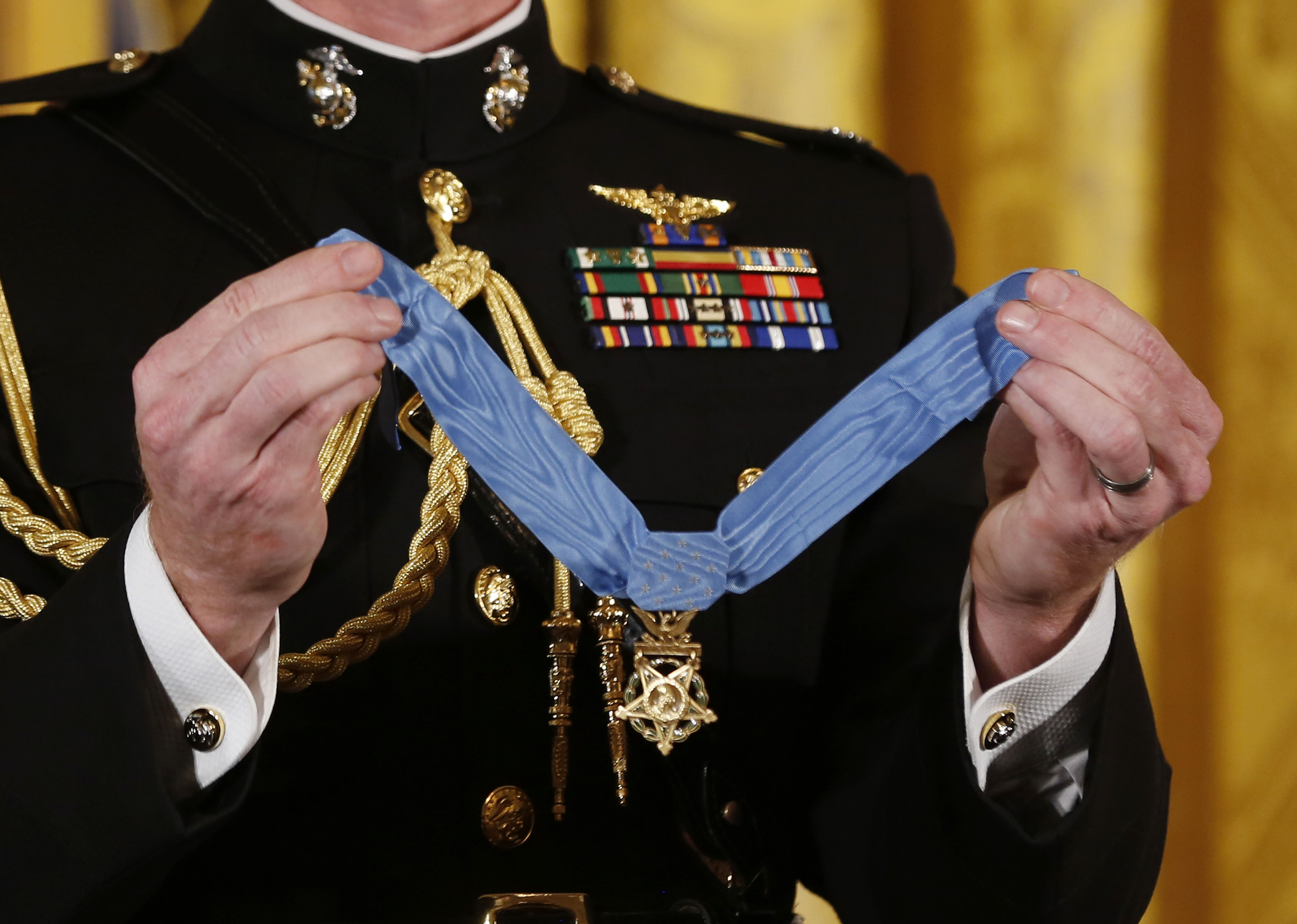 Meyer holds the Medal of Honor before U.S. President Obama presents it to Army Specialist Four Santiago Erevia, one of 24 U.S. Army veterans awarded the medal in Washington