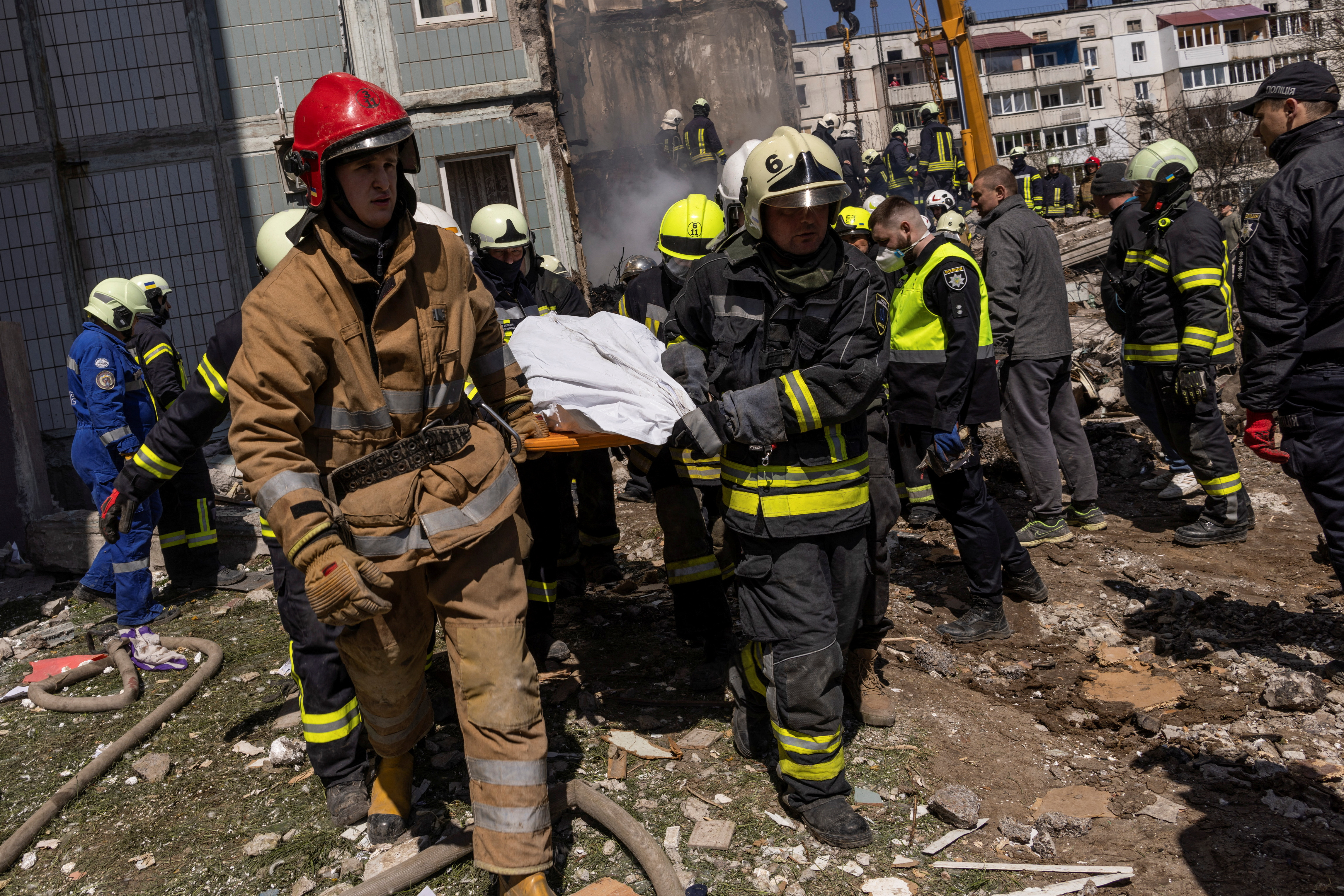 Rescuers work at the site of a damaged residential building hit by a Russian missile, amid Russia's attack on Ukraine, in the town of Uman