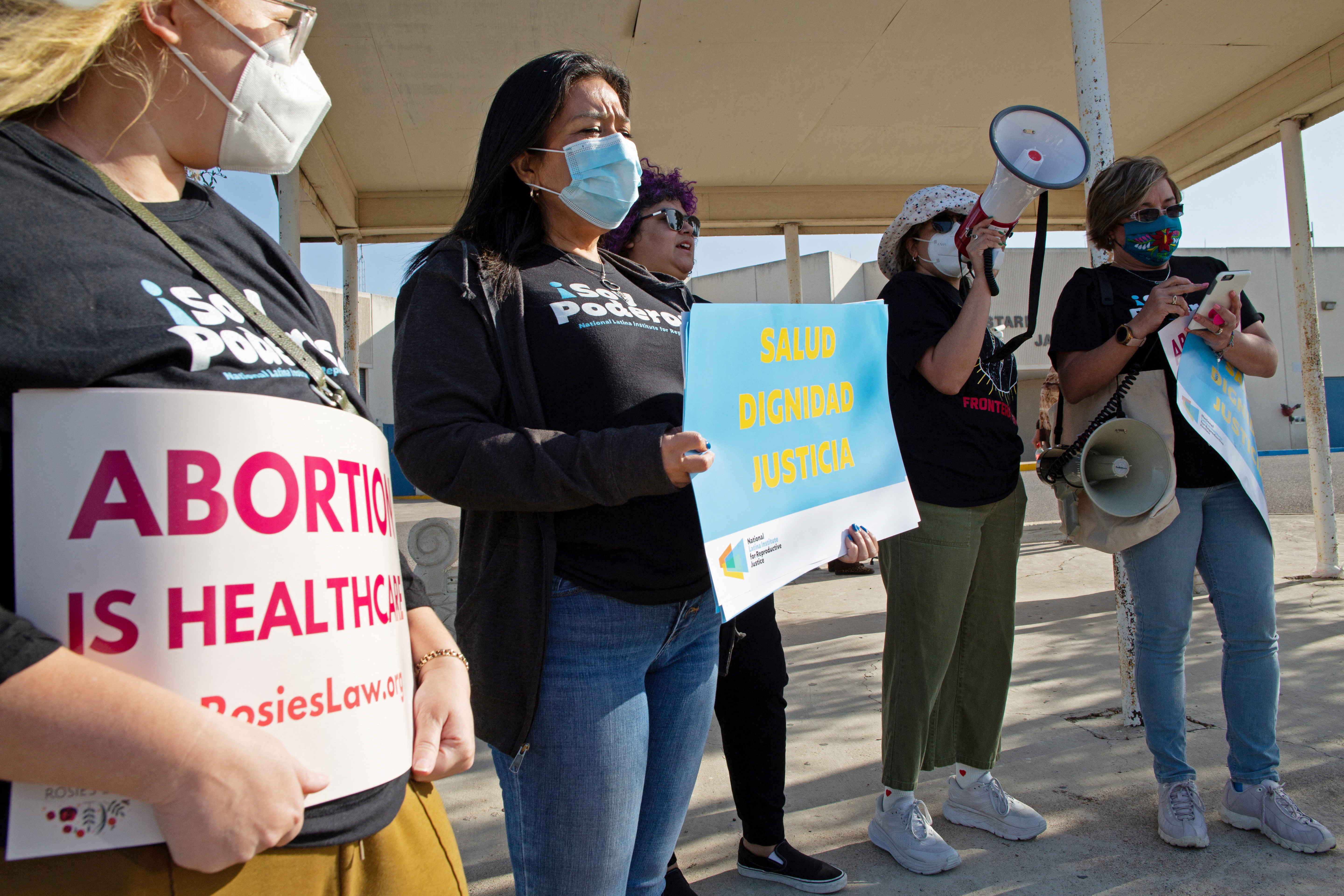Protesters stand outside the Starr County Jail over abortion charge