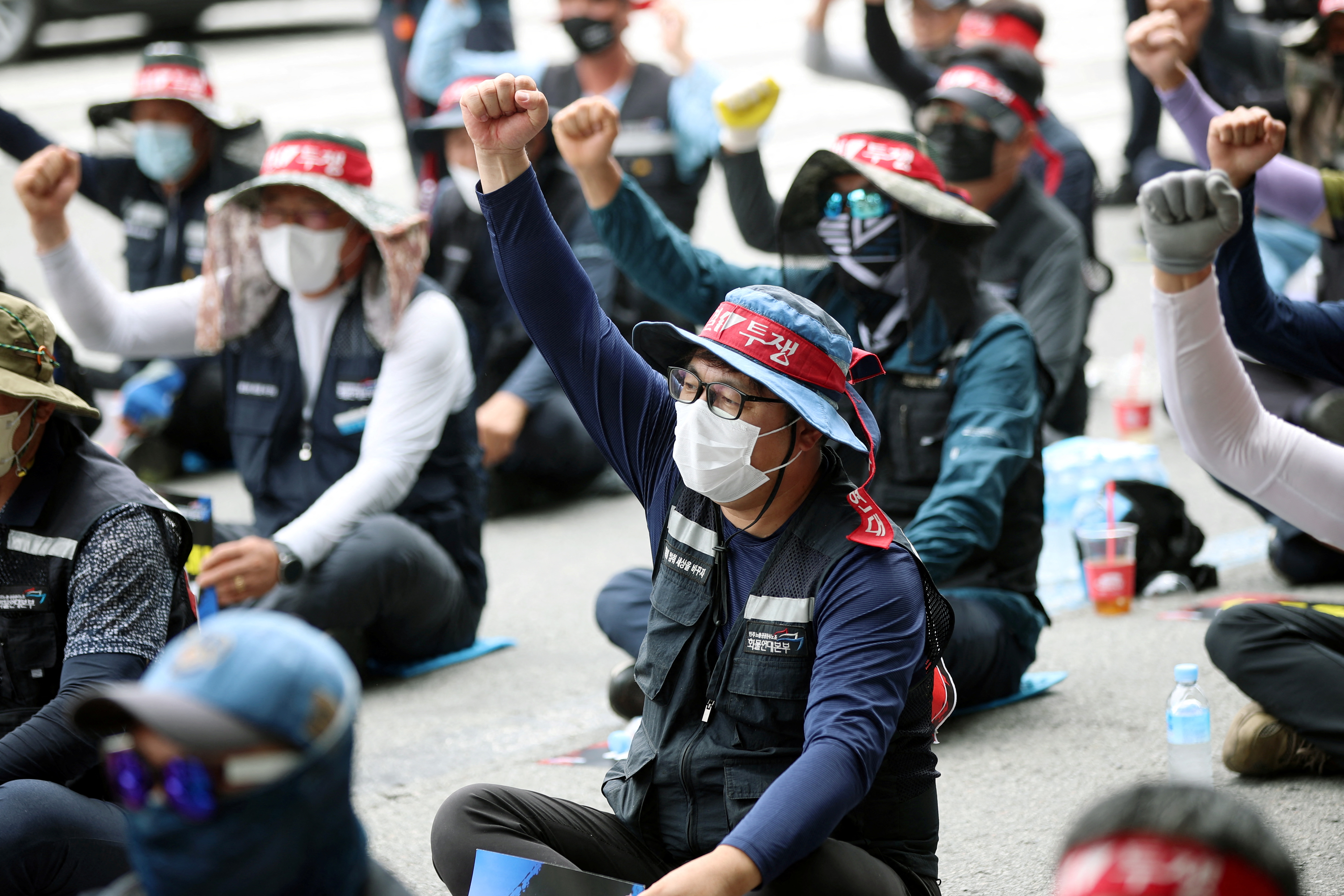 Members of the Cargo Truckers Solidarity union take part in a protest in front of Kia Motor's factory tin Gwangju