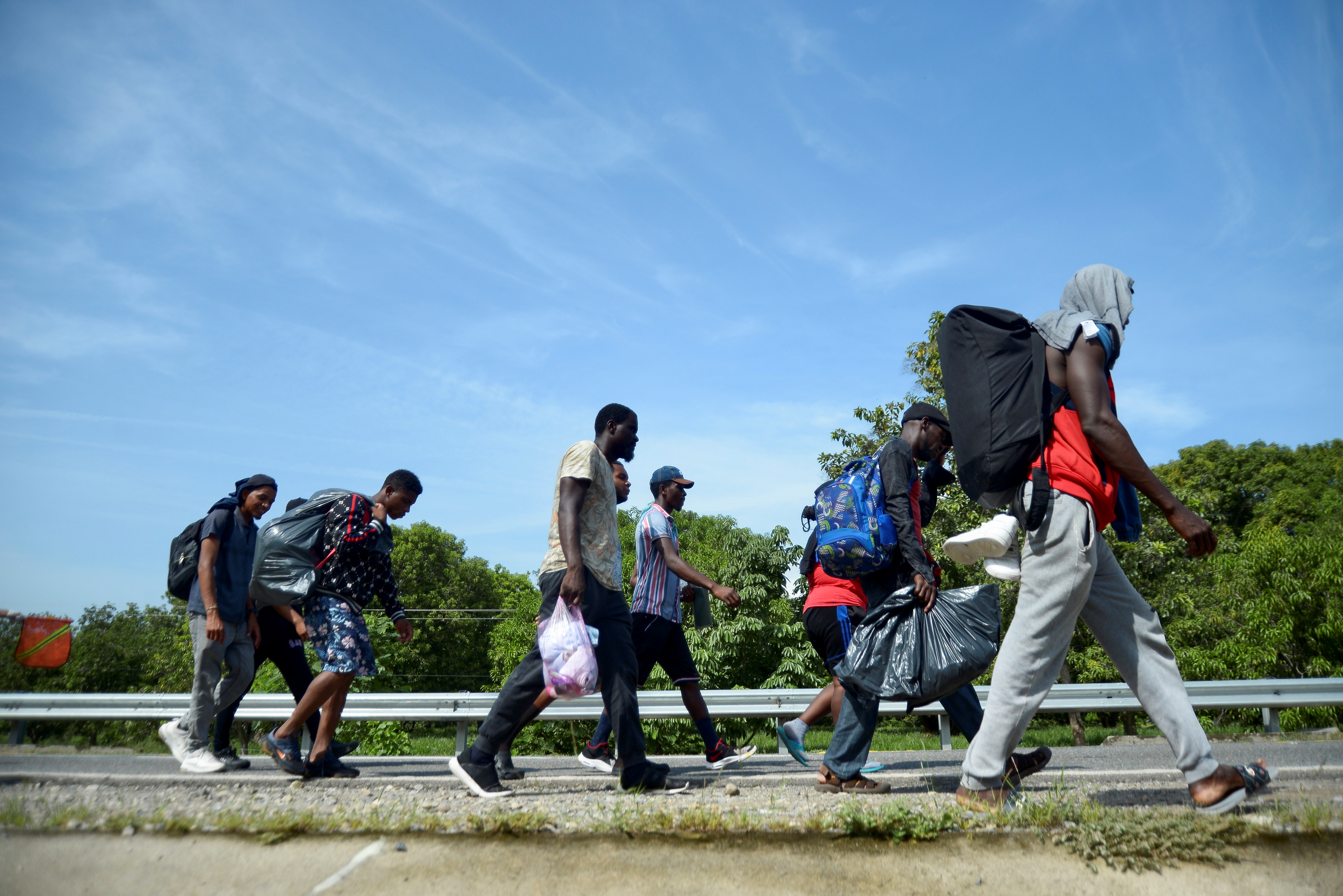 Migrants and asylum seekers from Central America and the Caribbean walk in a caravan headed to the Mexican capital to apply for asylum and refugee status, on a highway in Escuintla, in Chiapas state, Mexico August 31, 2021. REUTERS/Jacob Garcia