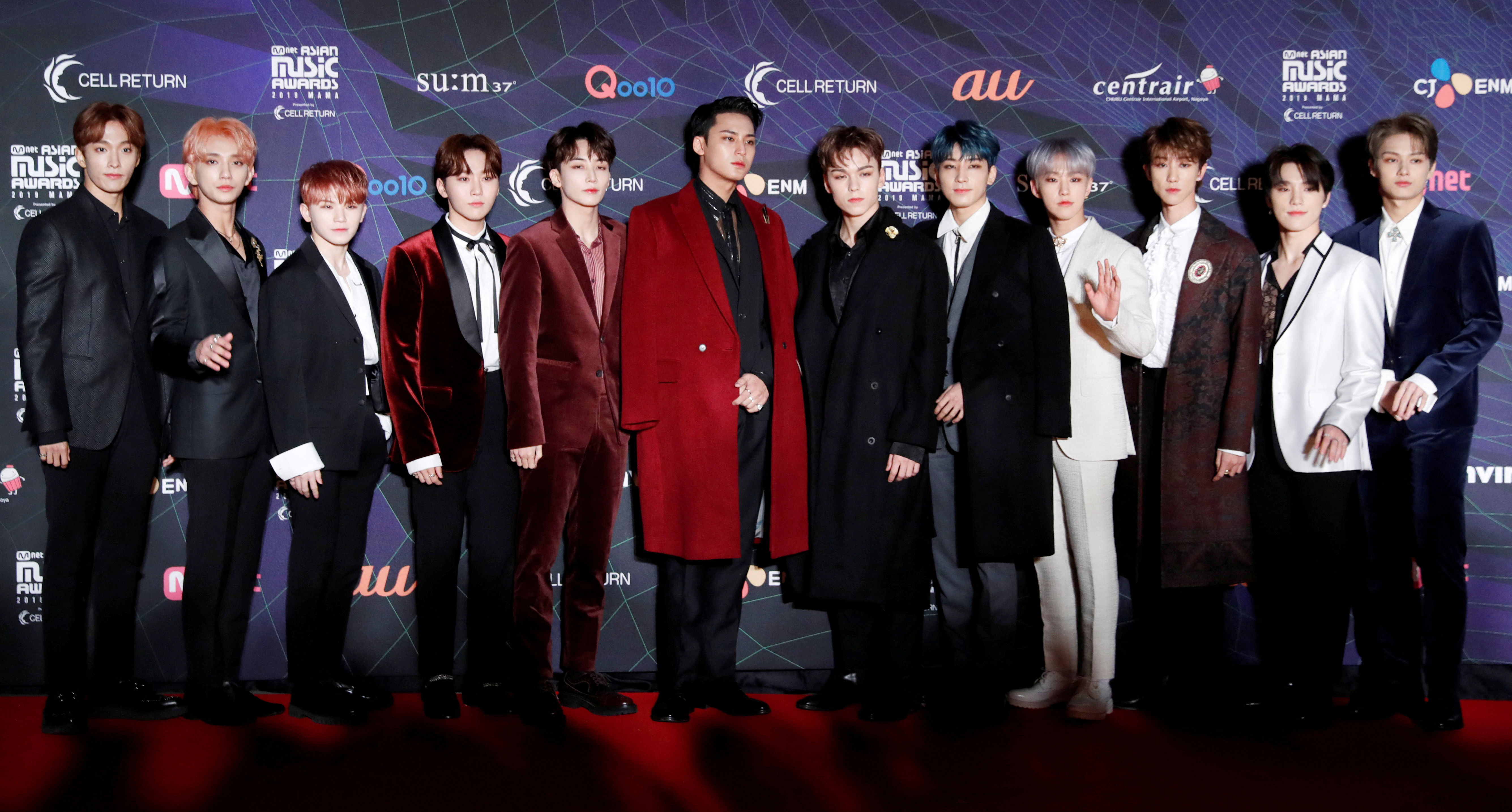 Members of South Korean boy band SEVENTEEN pose on the red carpet during the annual MAMA Awards at Nagoya Dome in Nagoya