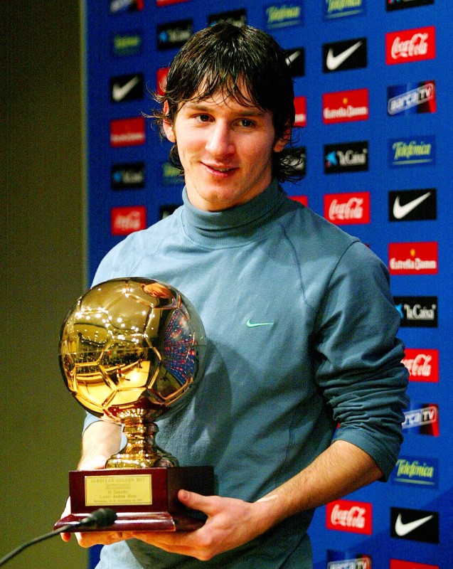 Barcelona's Messi from Argentina poses with Golden Boy trophy in Barcelona