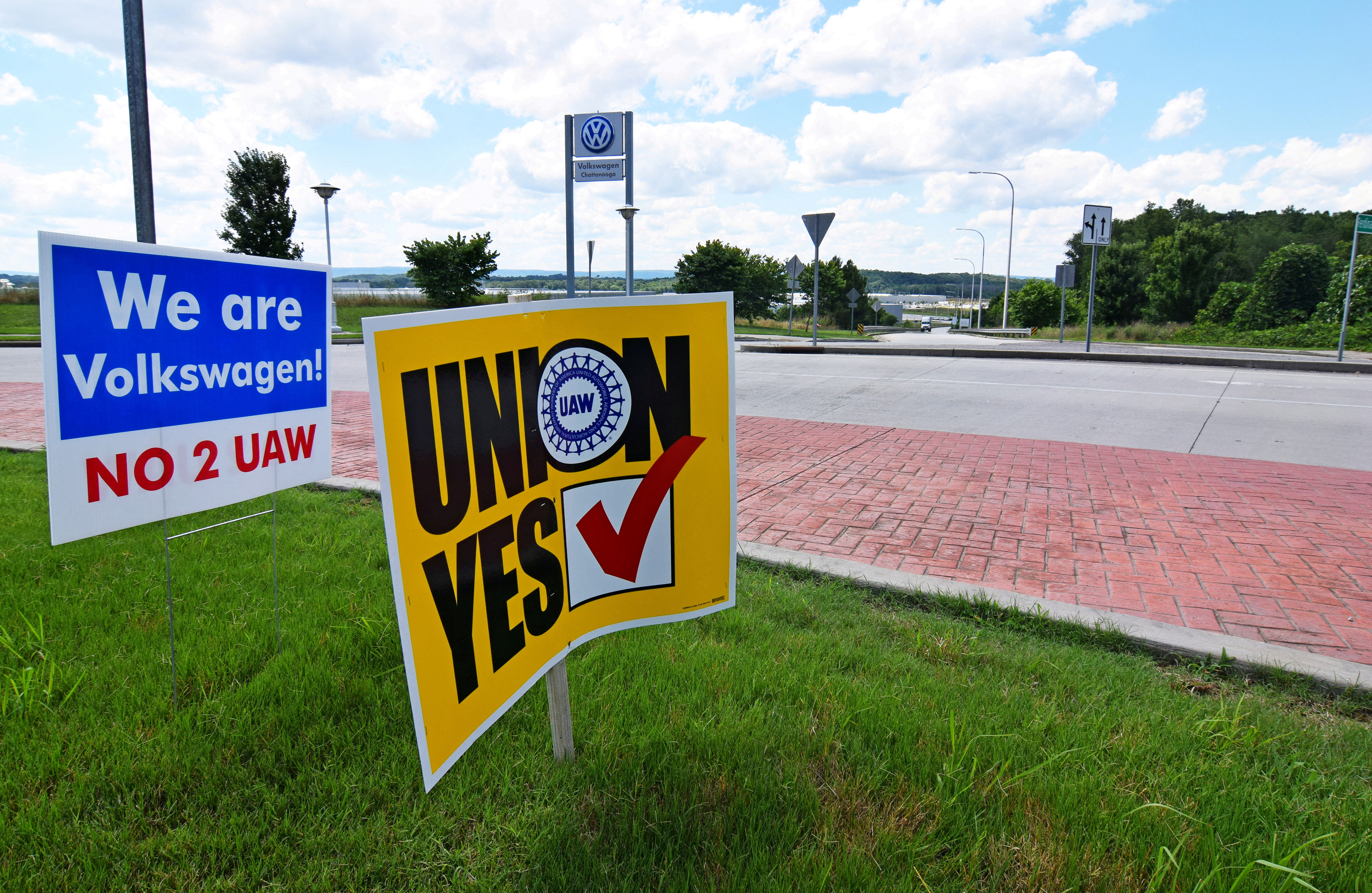 Signs stand outside a Volkswagen plant during a vote among local workers over whether or not to be represented by the United Auto Workers union in Chattanooga,