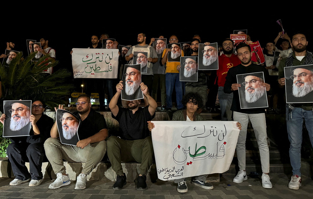 Supporters of Lebanon's Hezbollah leader Sayyed Hassan Nasrallah carry his pictures as  they gather in Sidon