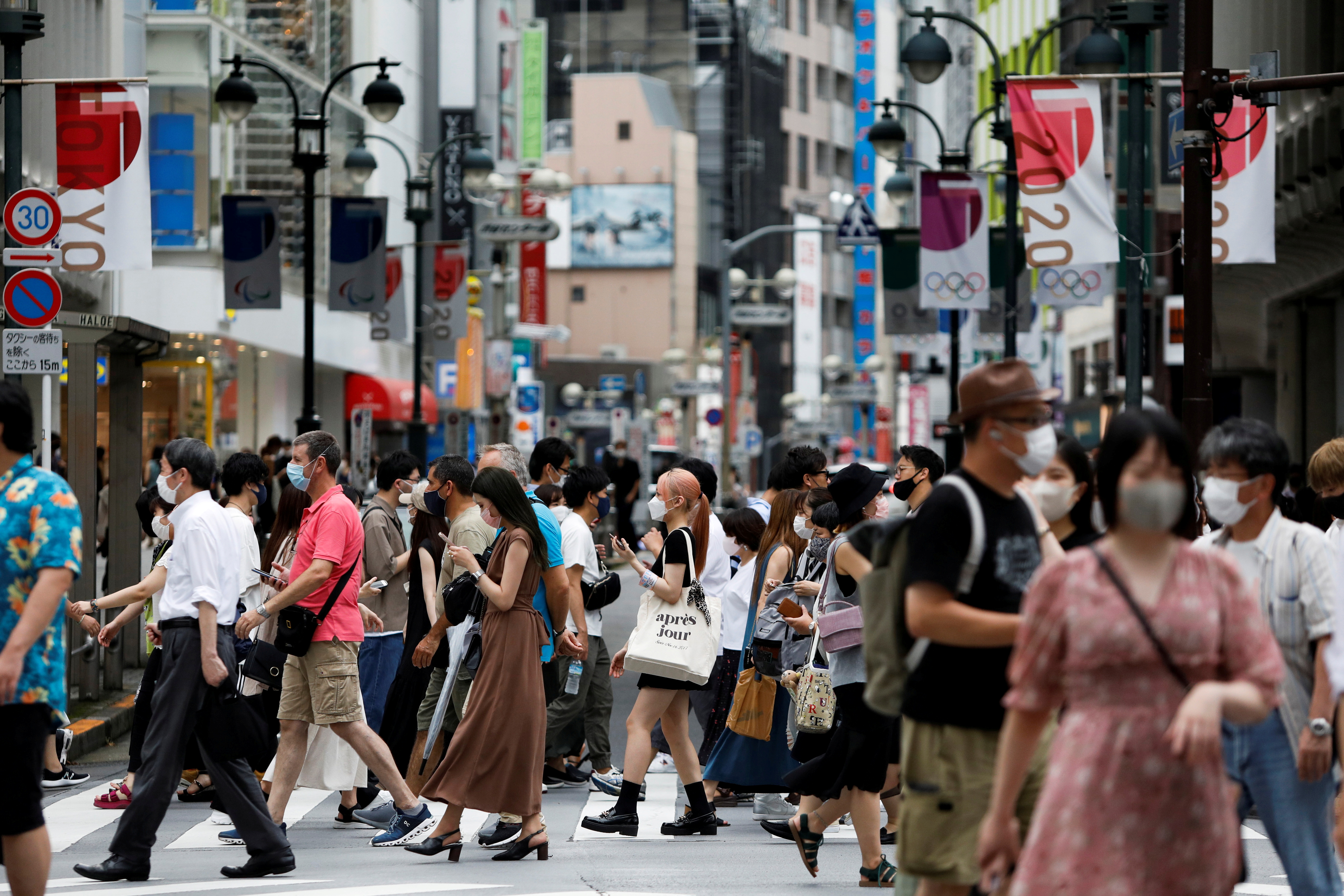 People walk at a crossing in Shibuya shopping area, amid the coronavirus disease (COVID-19) pandemic, in Tokyo