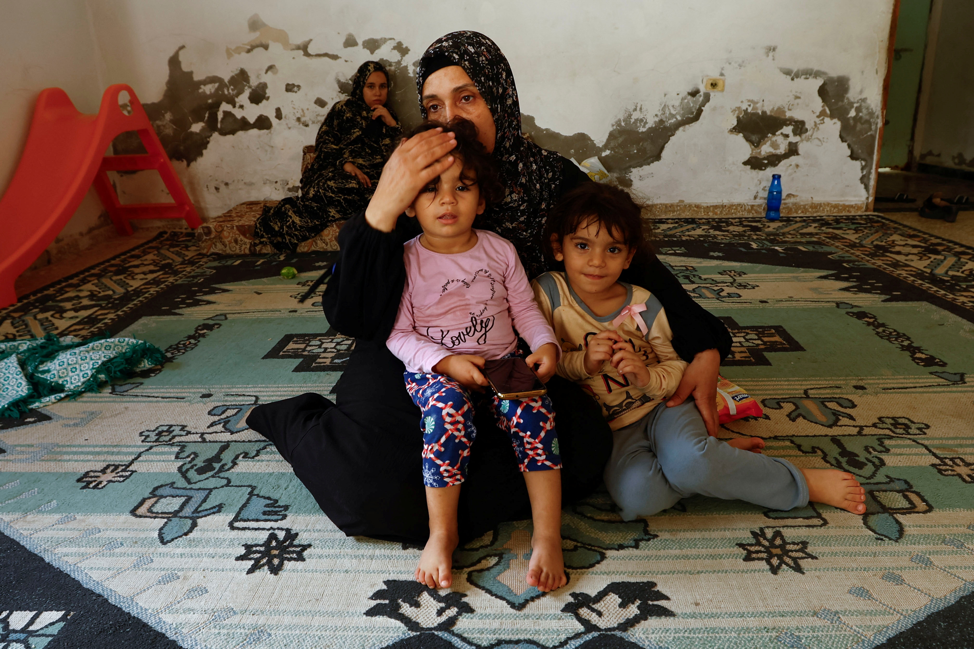Fleeing Gaza mother cries: 'What did my children do to deserve