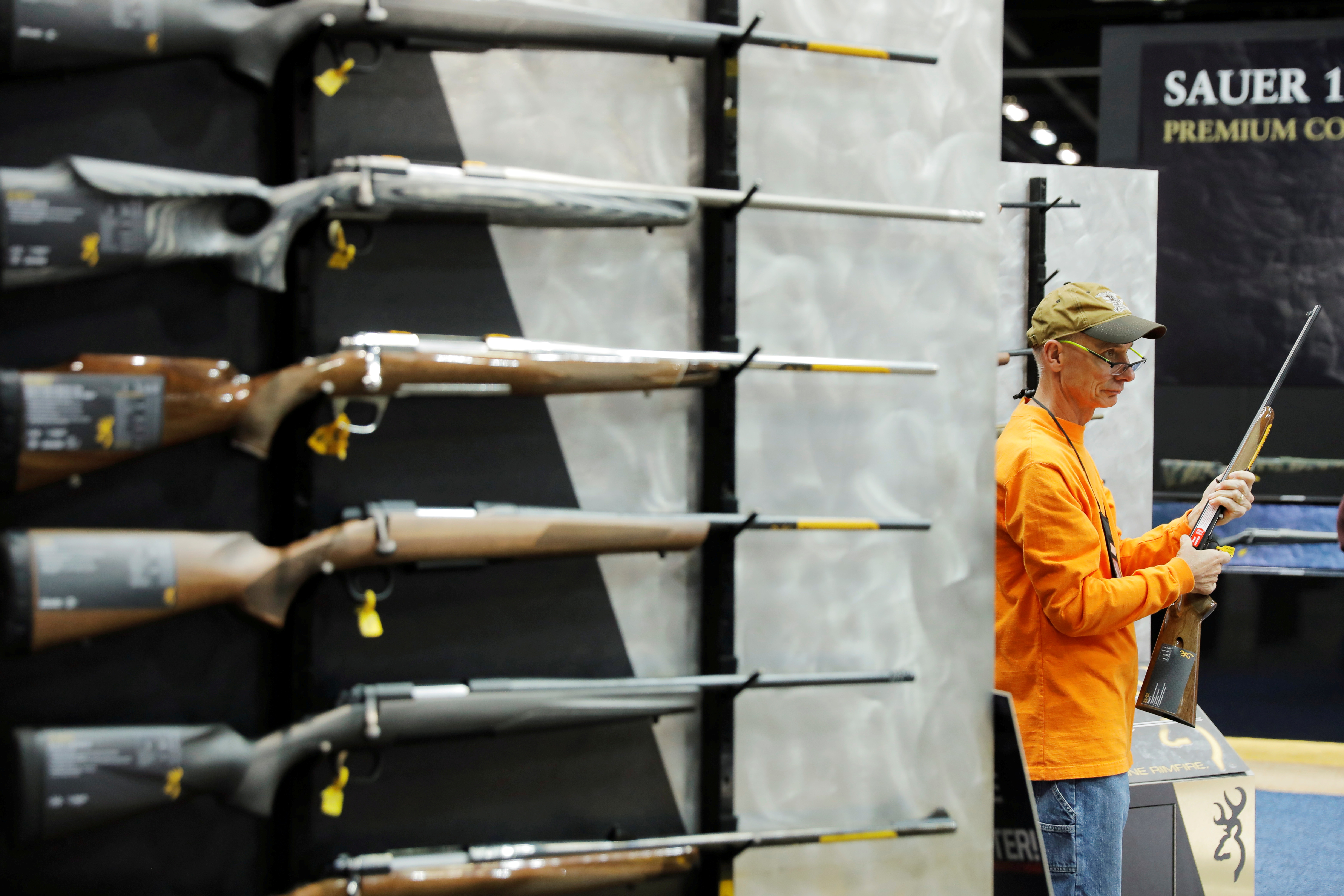 A man inspects a Browning shotgun during the National Rifle Association (NRA) annual meeting in Indianapolis, Indiana