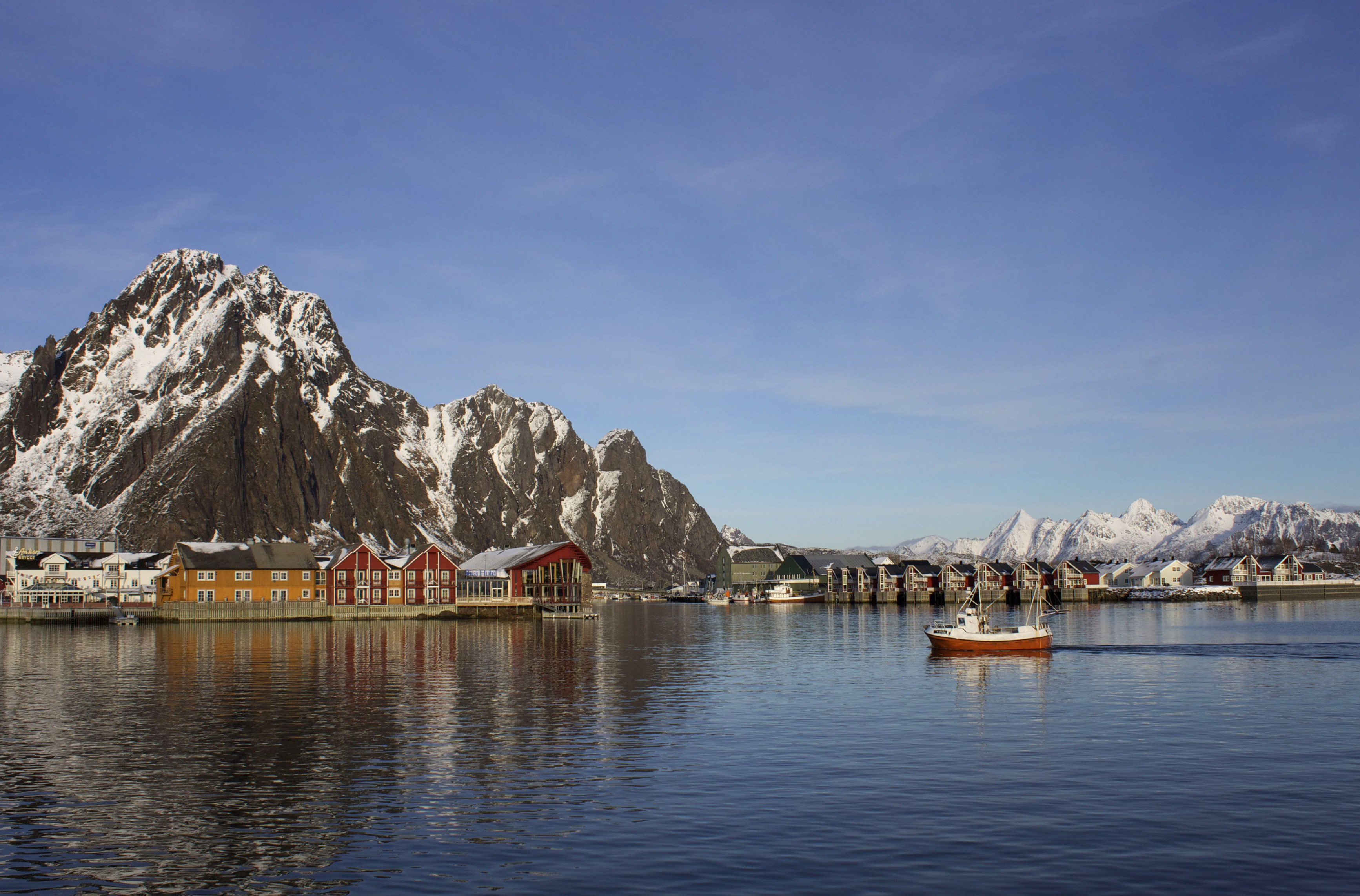 A fishing boat enters the harbor at the Arctic port of Svolvaer in northern Norway