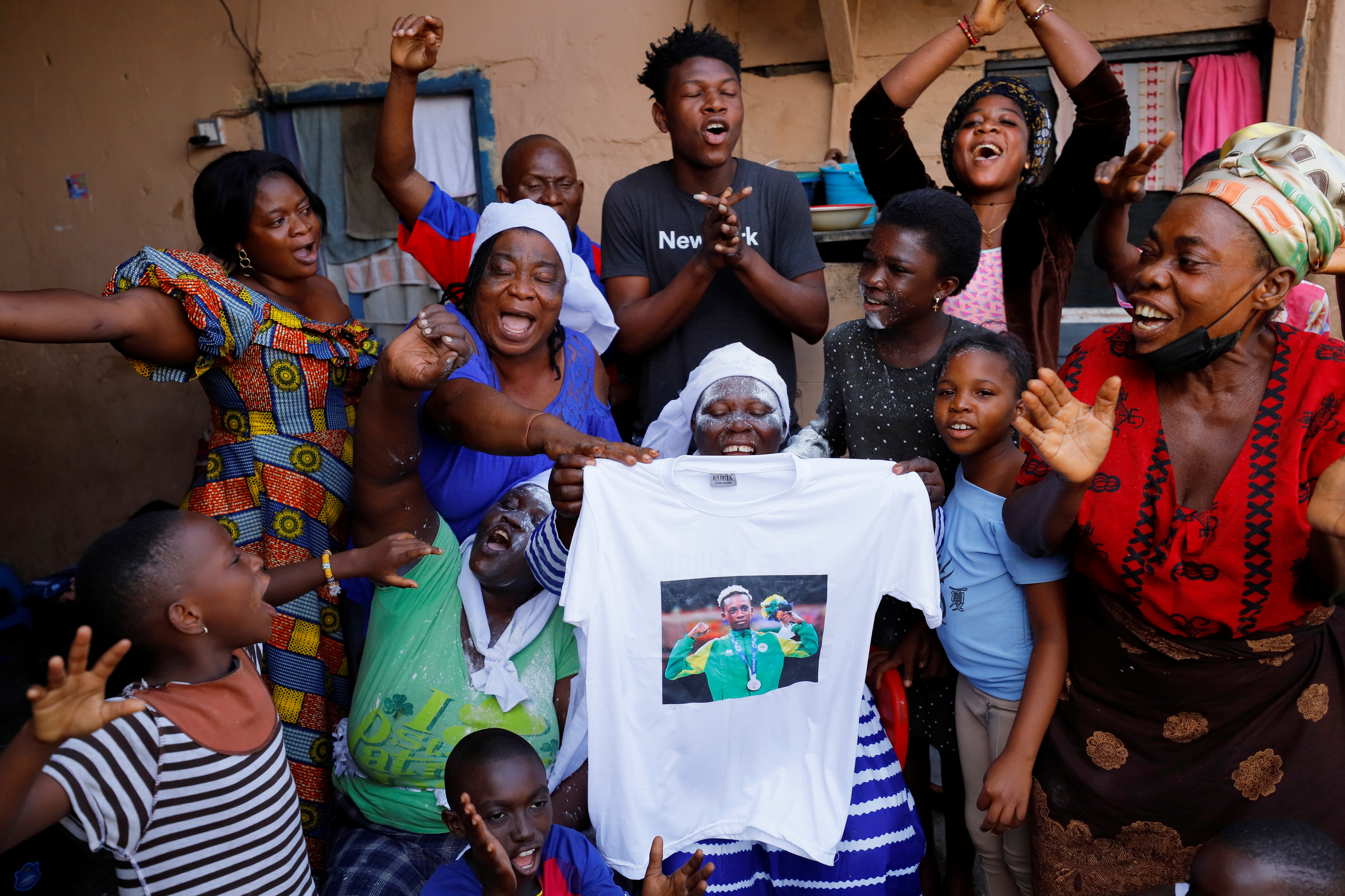 Family of Ghana's boxer Samuel Takyi, celebrate as they await his return home in Accra