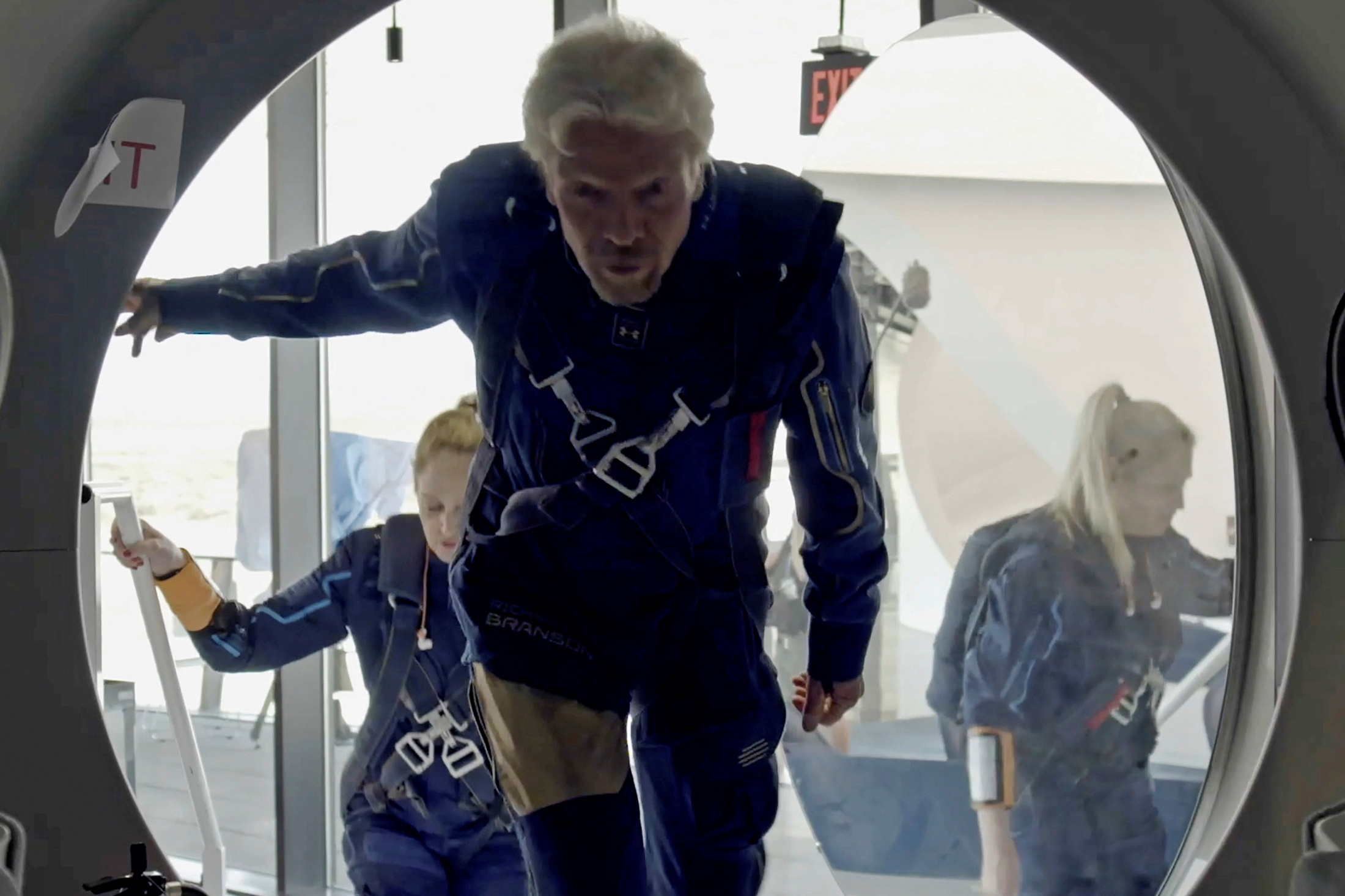Richard Branson and Virgin Galactic crew members enter the VSS Unity