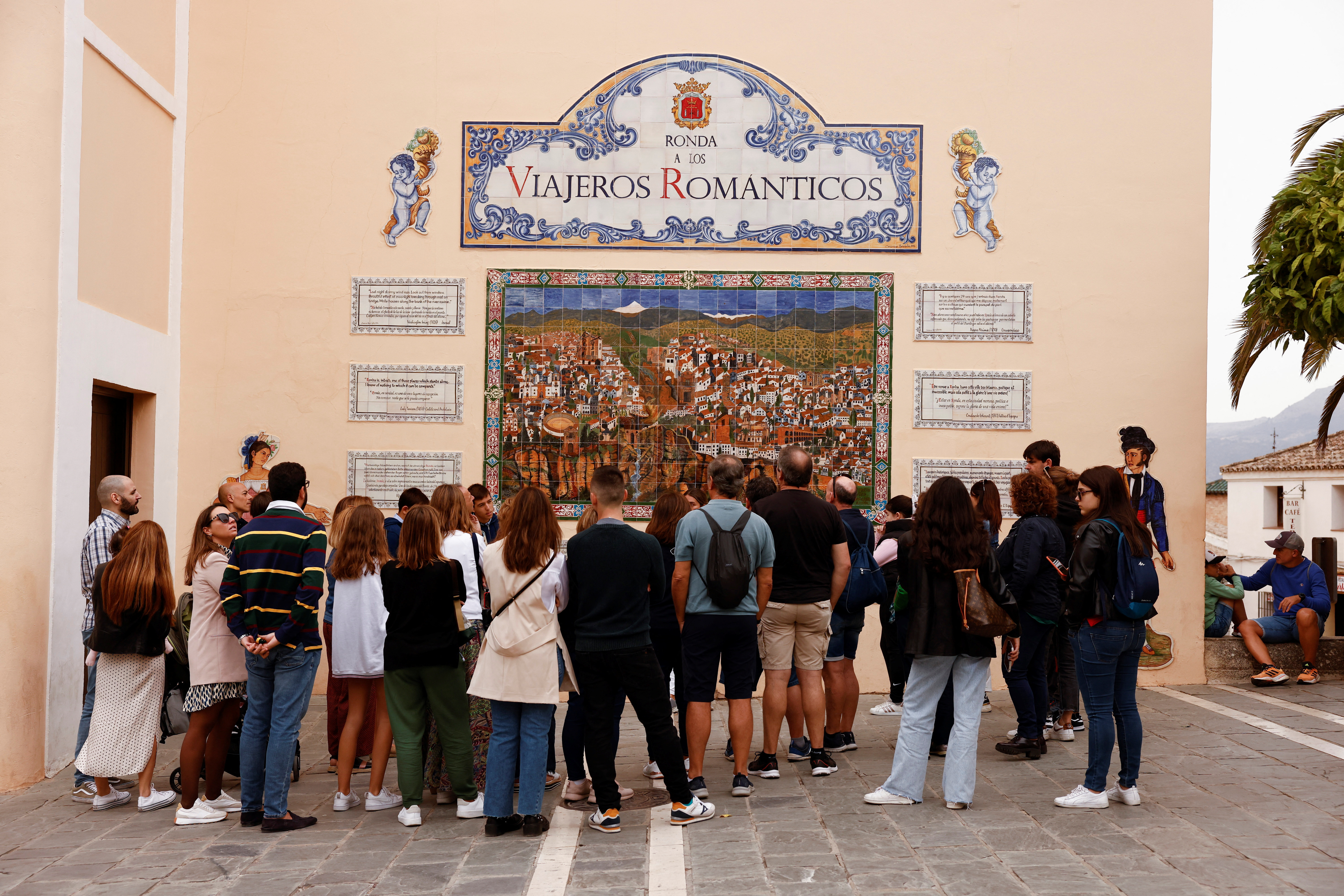 Tourists listen to a guide during a tour in Ronda