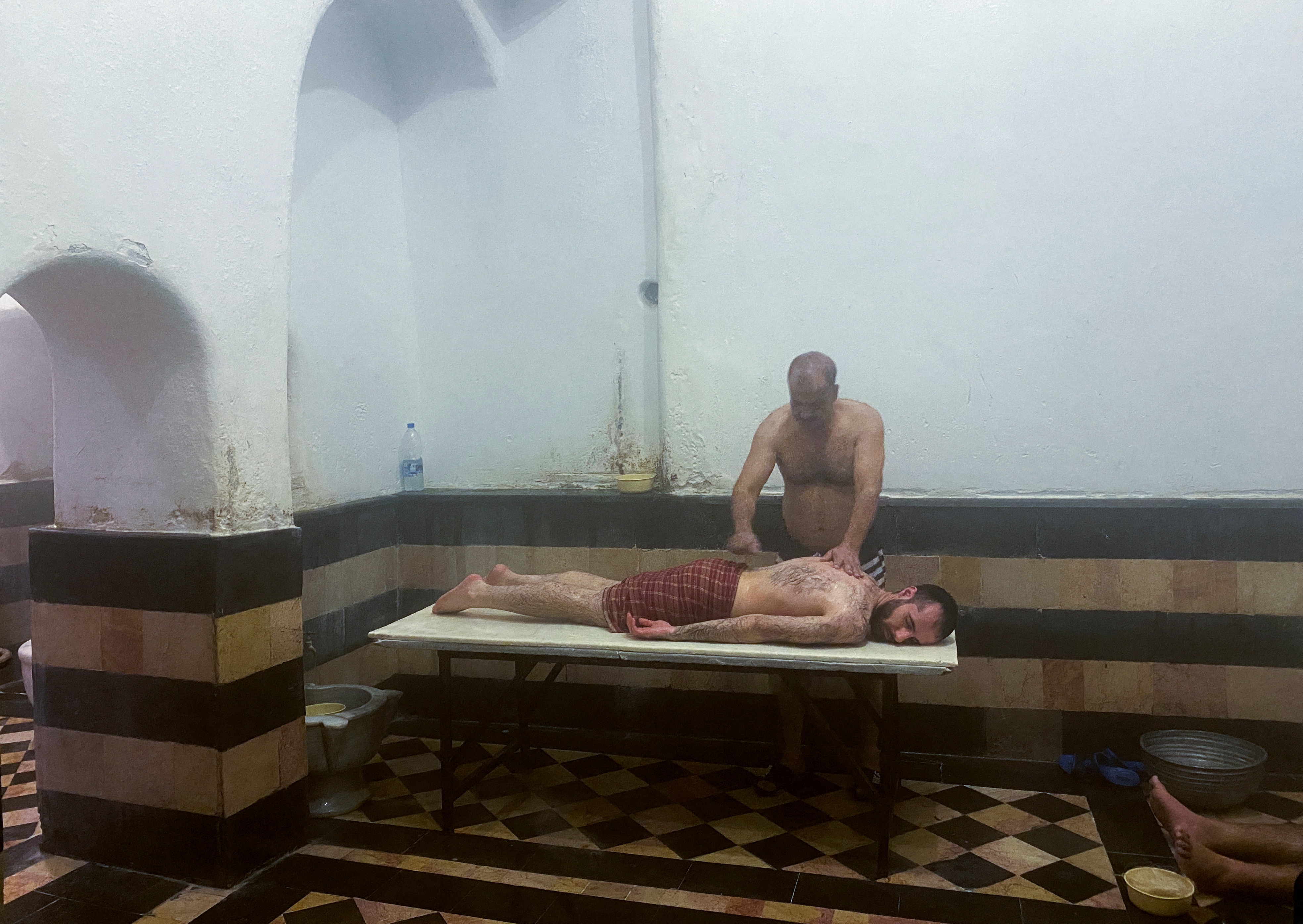 An attendant gives a massage to a customer at a bathhouse in Damascus