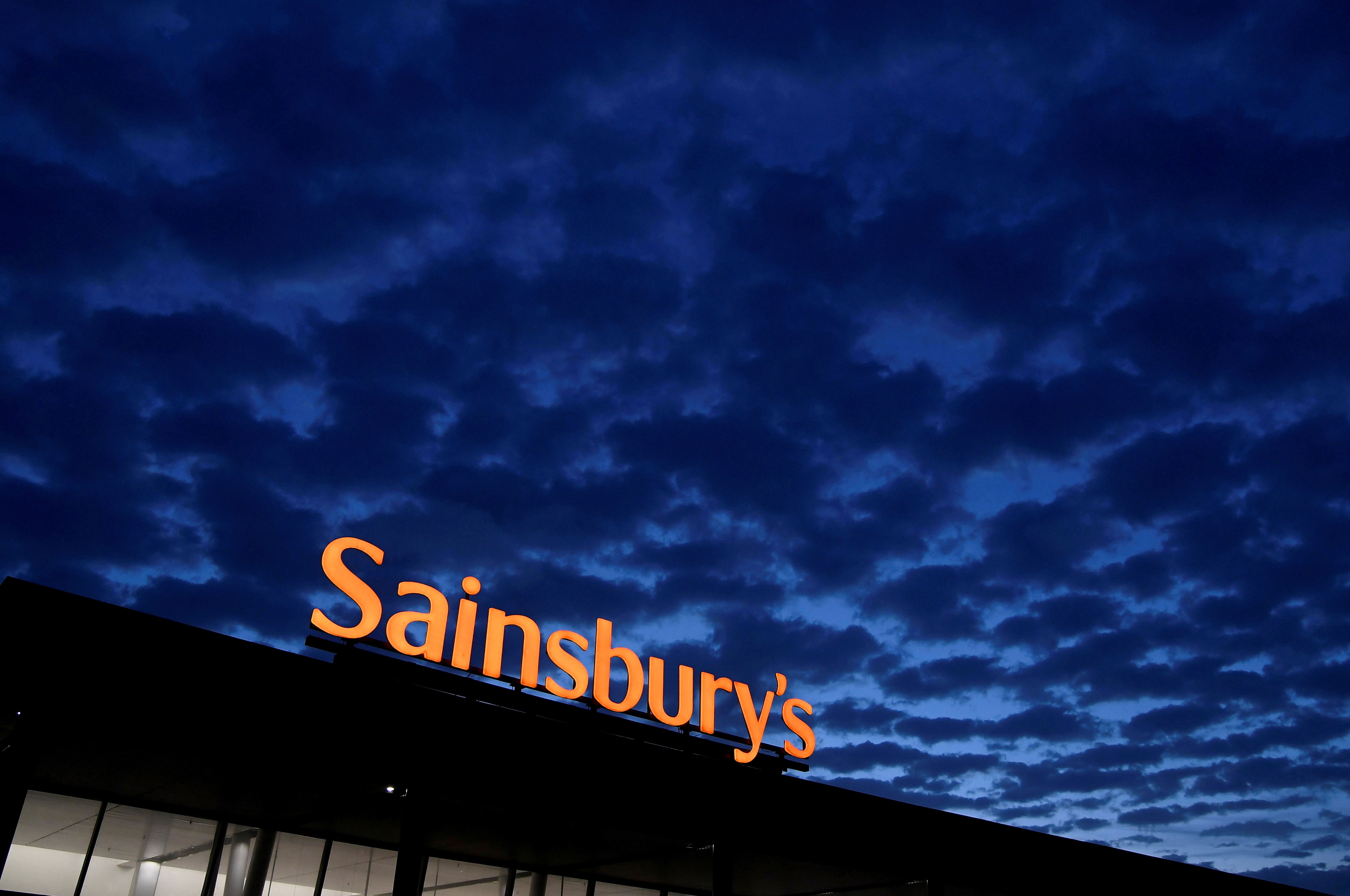 FILE PHOTO: Signage for Sainsbury's is seen at a branch of the supermarket in London