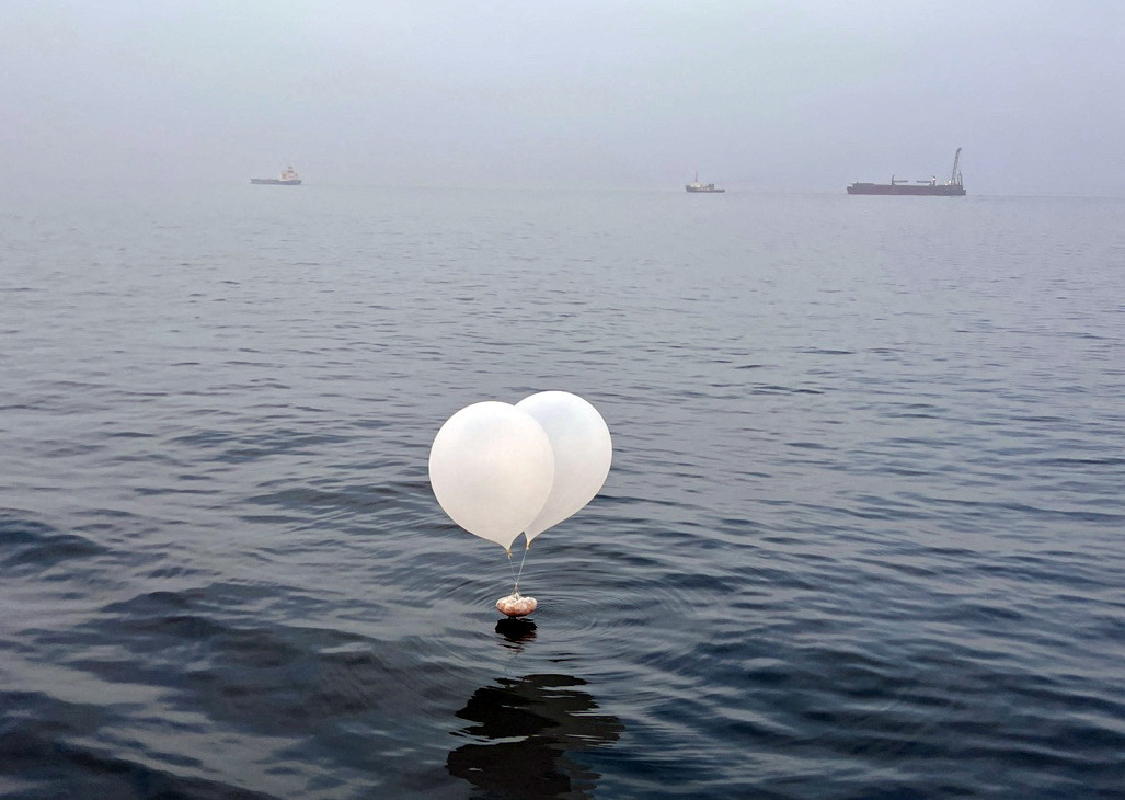 A balloon carrying various objects including what appeared to be trash, believed to have been sent by North Korea, is pictured at the sea off Incheon
