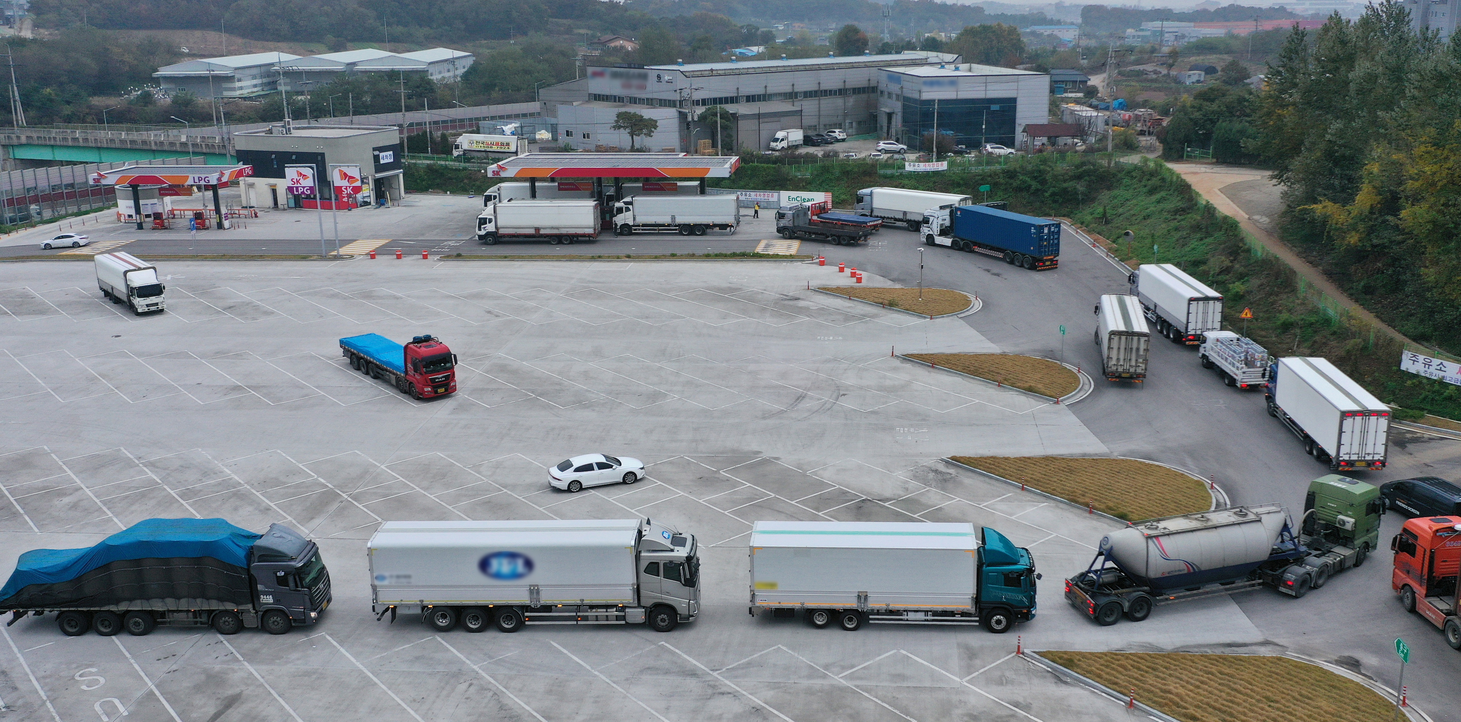 Trucks wait in a line to get urea at a service area in Pyeongtaek