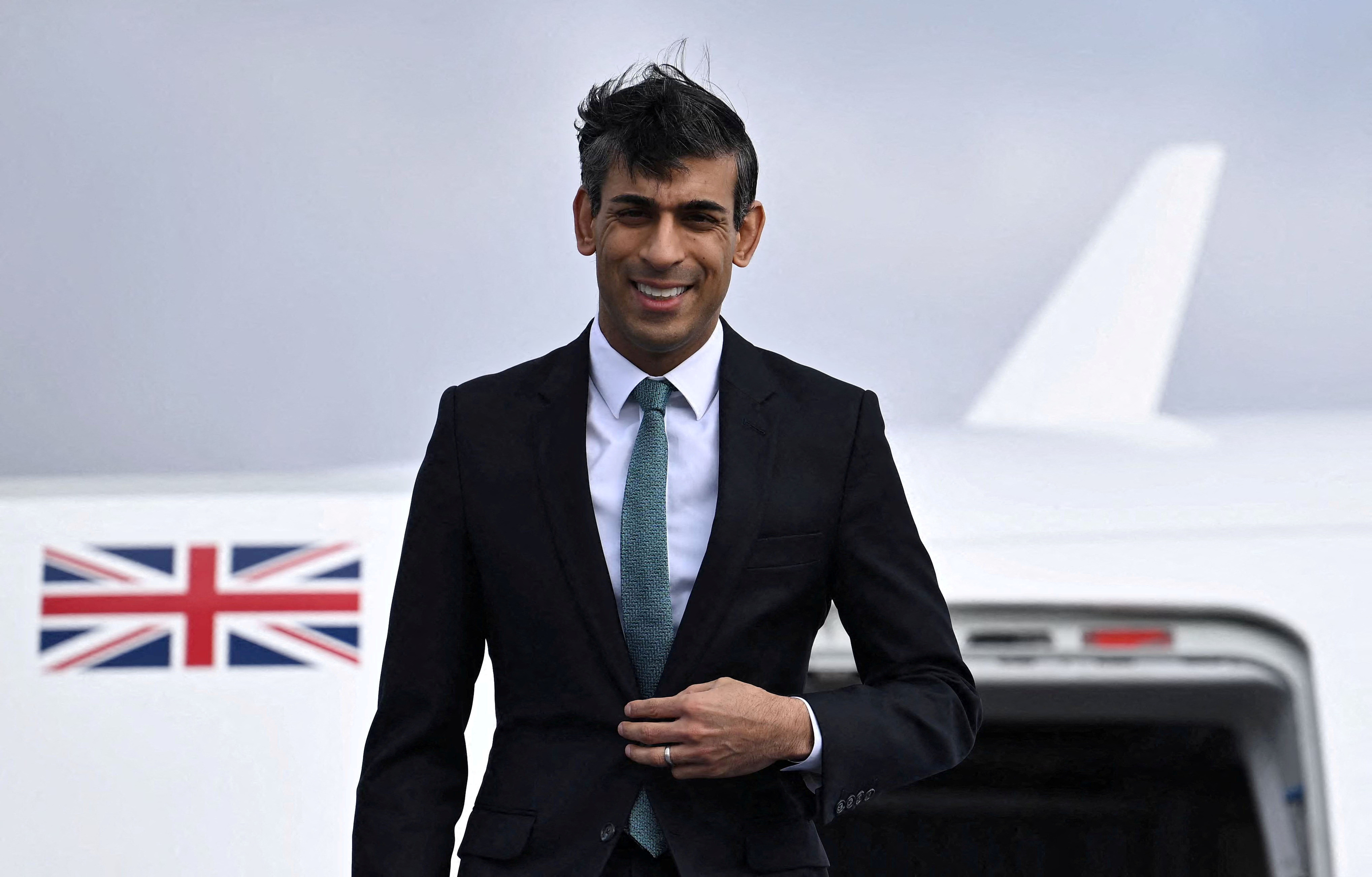 British Prime Minister Rishi Sunak gets off his plane after his arrival on February 18, 2023 at the airport in Munich