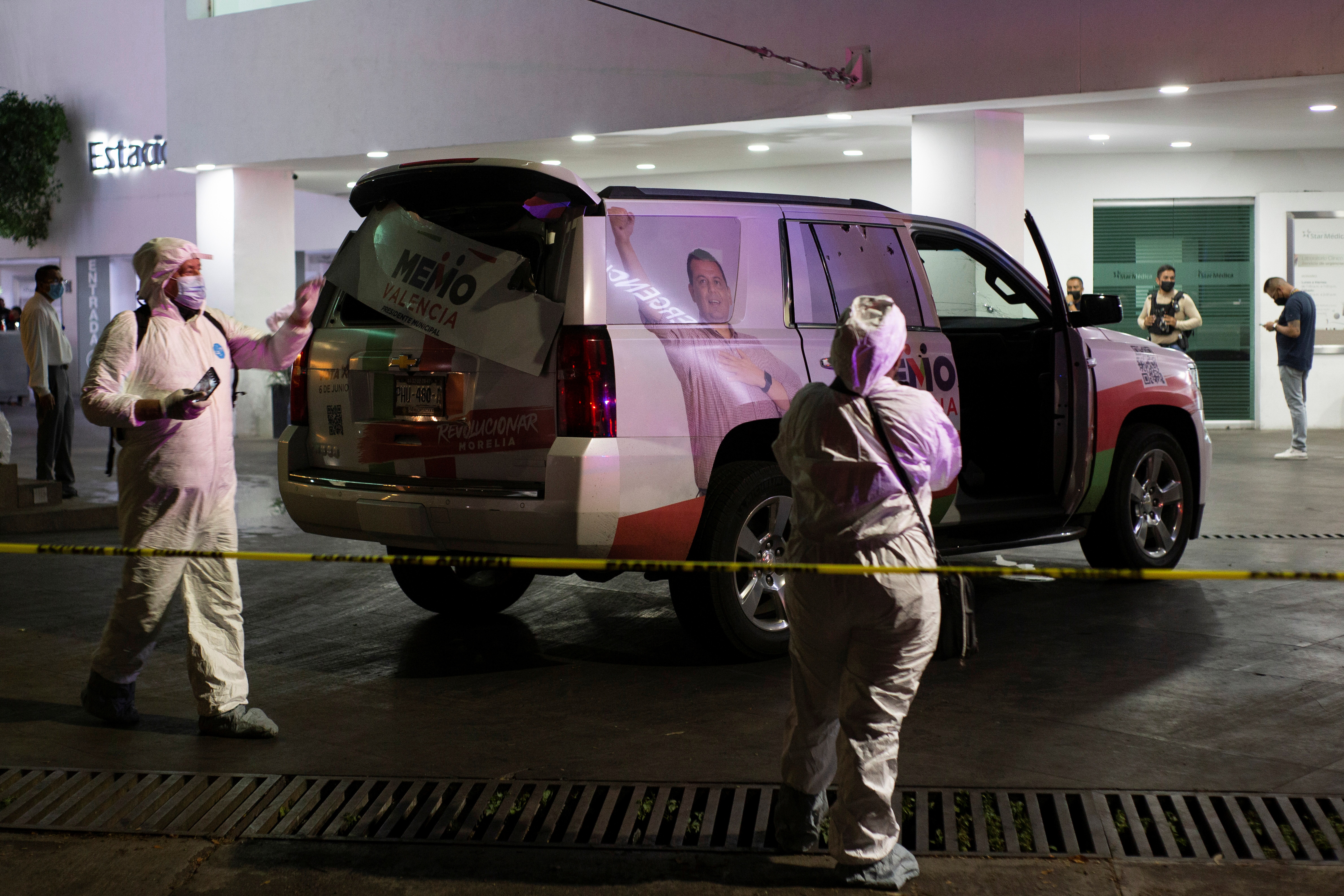 Forensic technicians work at a scene where unknown assailants attacked the truck of the campaign team of Guillermo Valencia, in Morelia