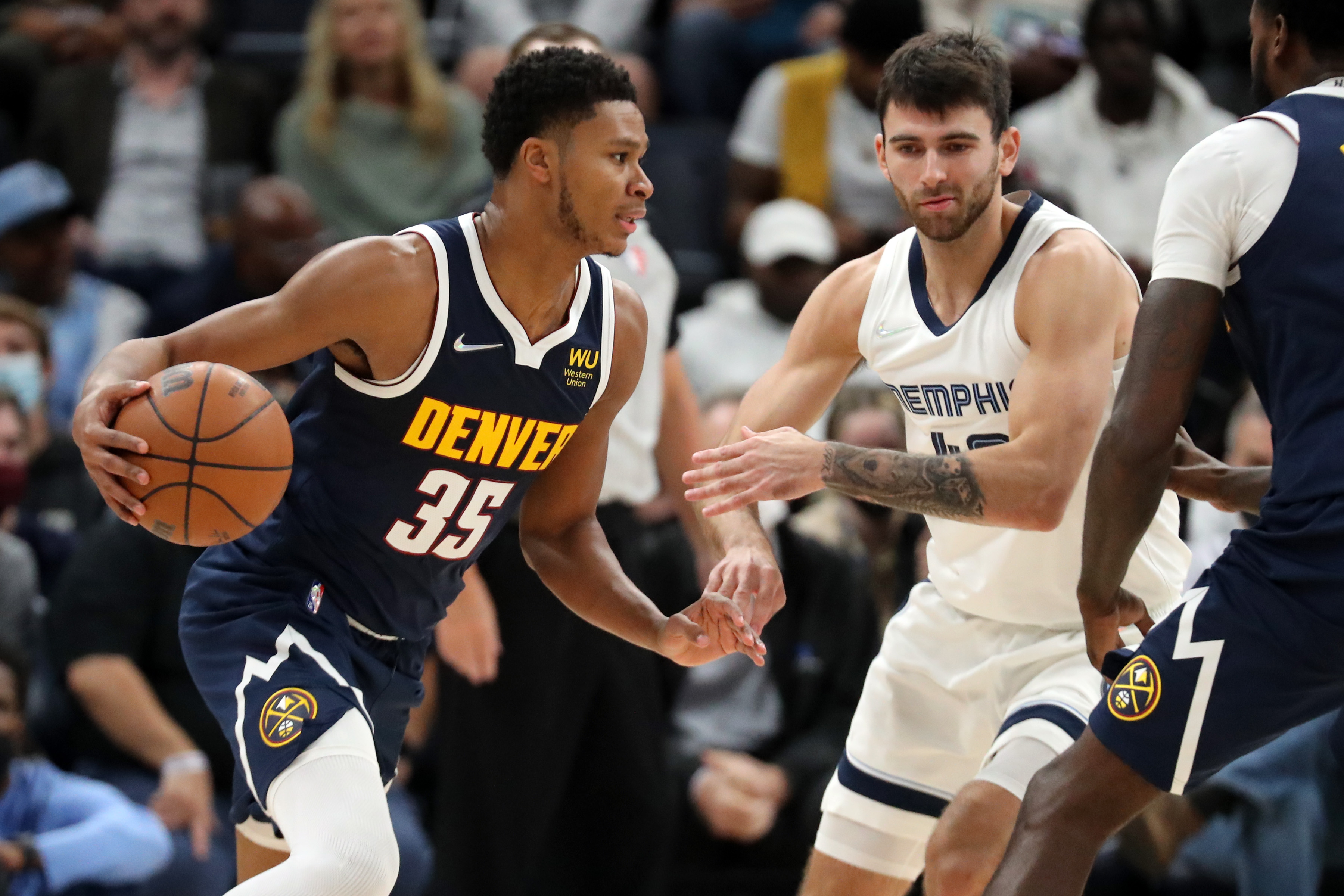 Nov 1, 2021; Memphis, Tennessee, USA; Denver Nuggets guard-forward P.J. Dozier (35) moves to the basket as Memphis Grizzles guard John Konchar (46) defends during the second half at FedExForum. Mandatory Credit: Petre Thomas-USA TODAY Sports
