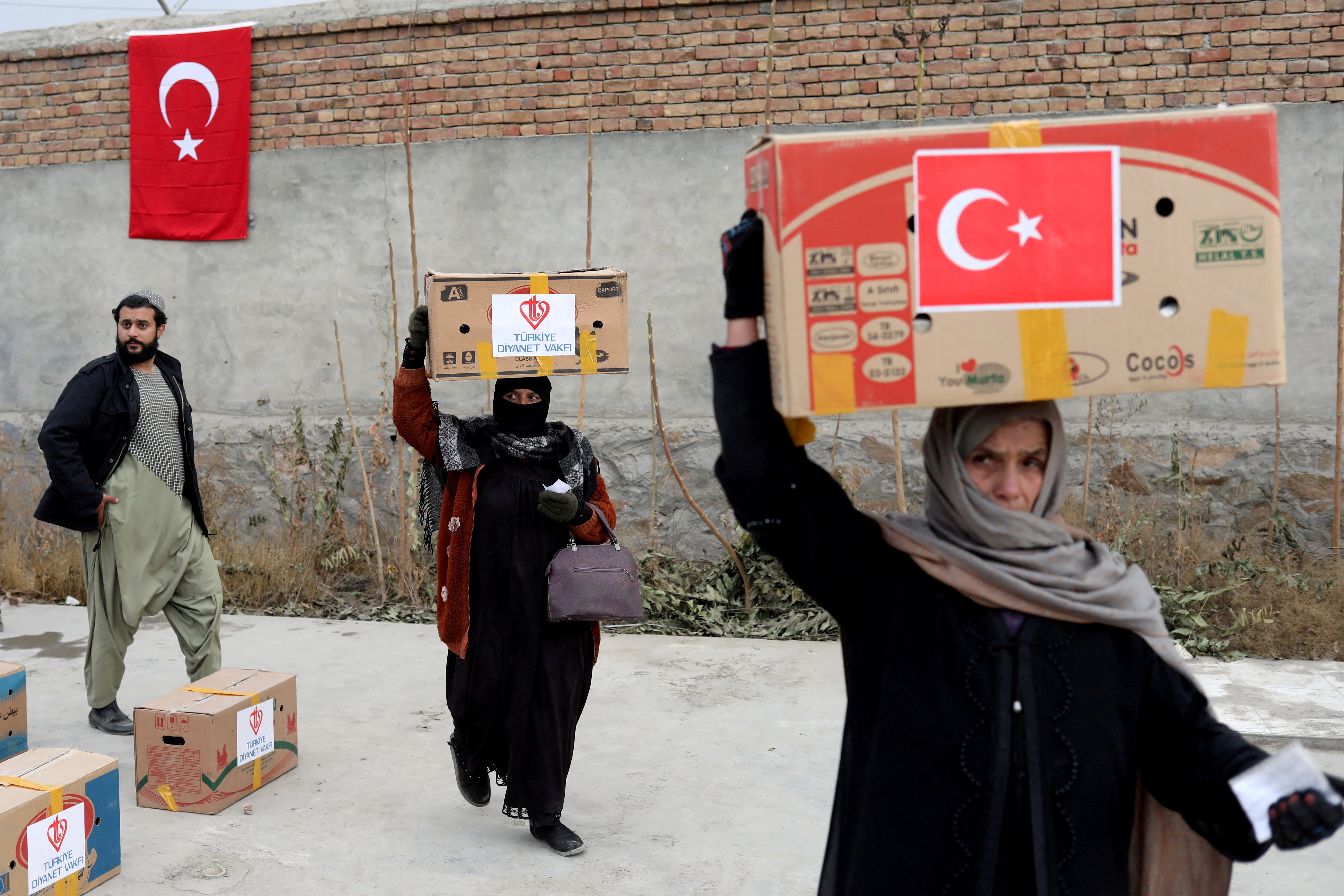 Packages from a Turkish humanitarian aid group distributed amongst Afghans in Kabul