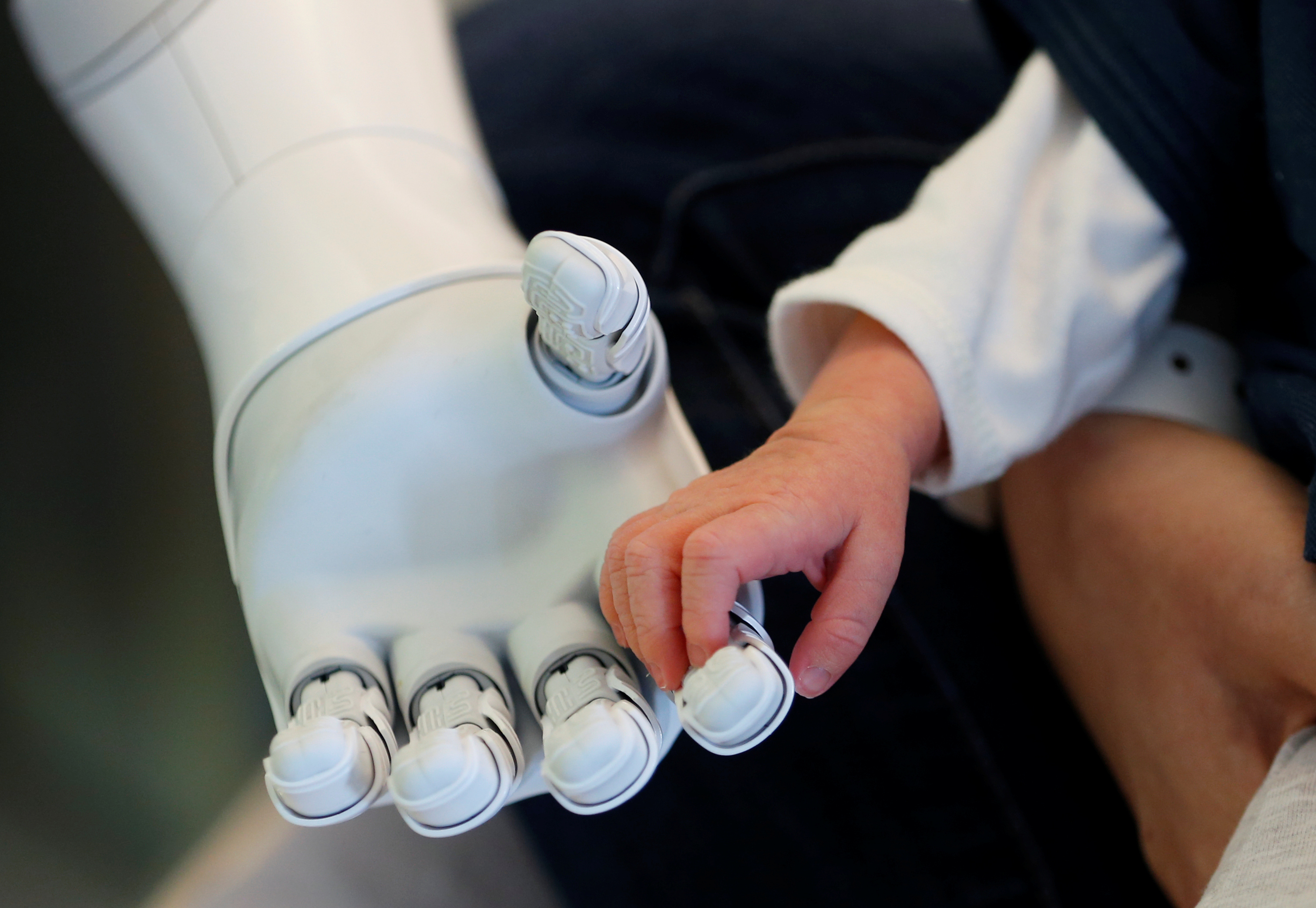 "Pepper" the robot holds the hand of a new born baby at AZ Damiaan hospital in Ostend,