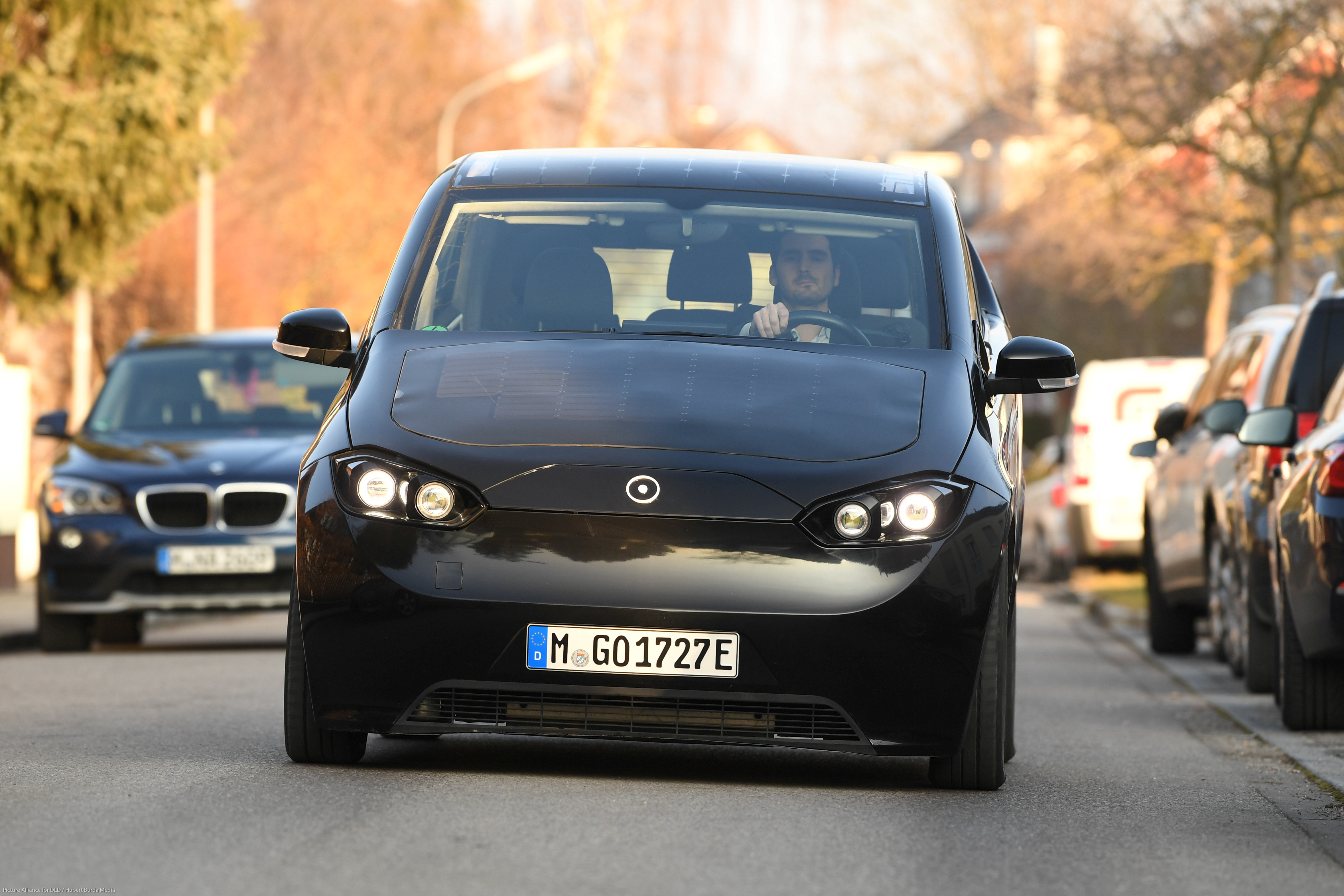 Laurin Hahn, co-founder of German solar-powered electric car startup Sono Motors, drives a prototype of their car in Munich