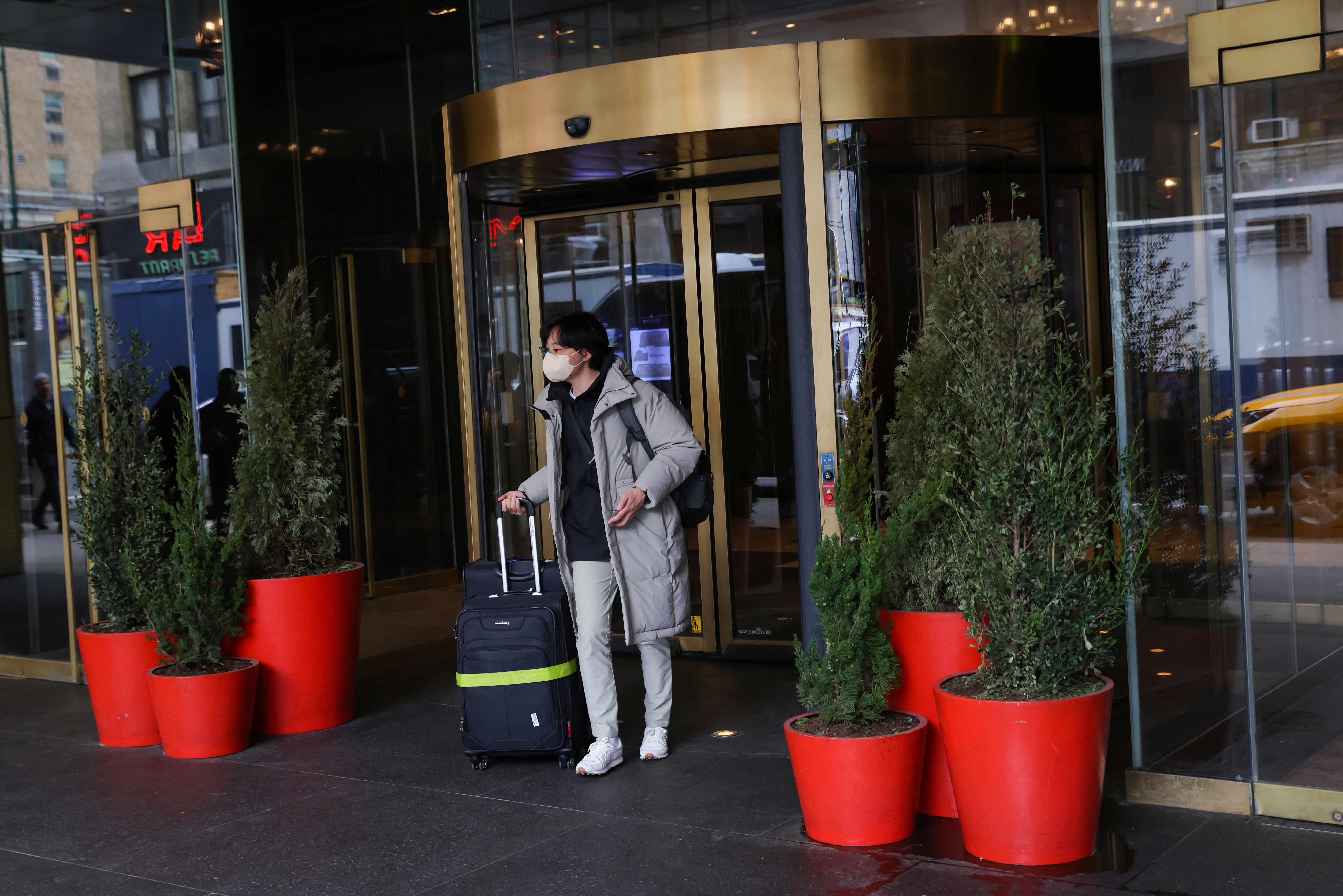 A person exits an InterContinental hotel in Manhattan, New York City