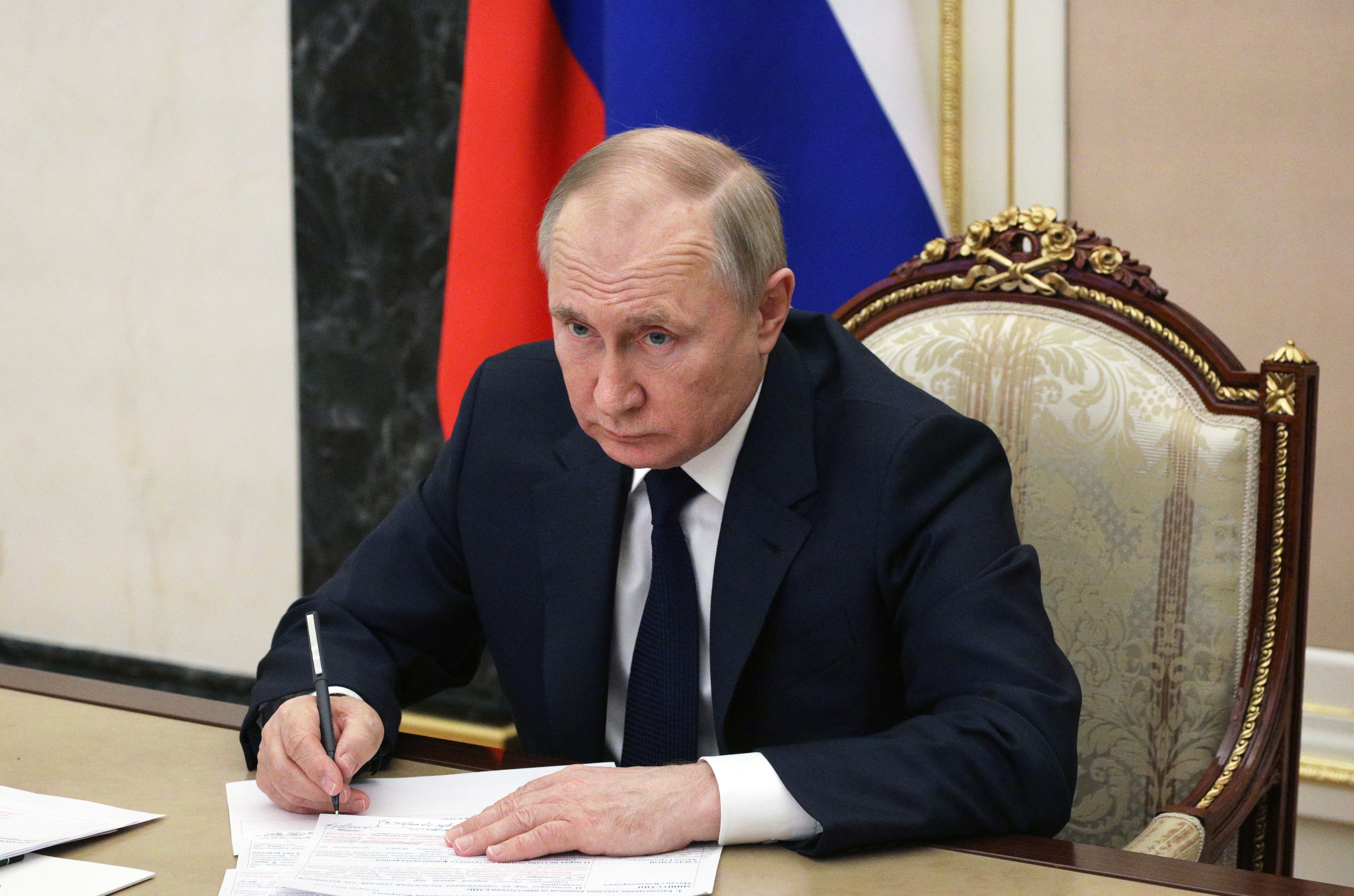 Russian President Vladimir Putin attends a meeting with government members via a video link in Moscow