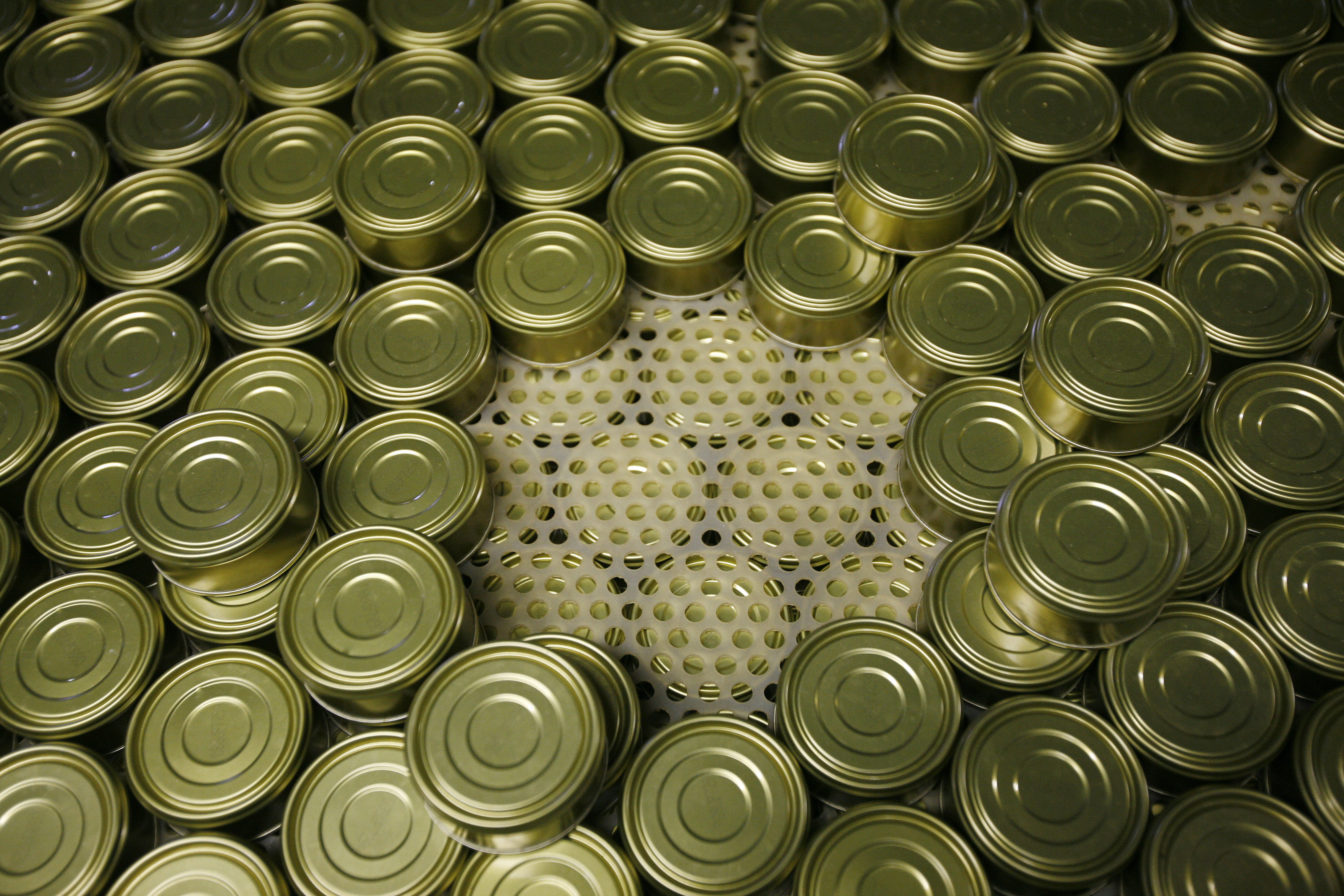Cans of pink salmon are stacked so that the heat can vent out of the stack after being cooked at the Alitak Cannery in Alitak, Alaska