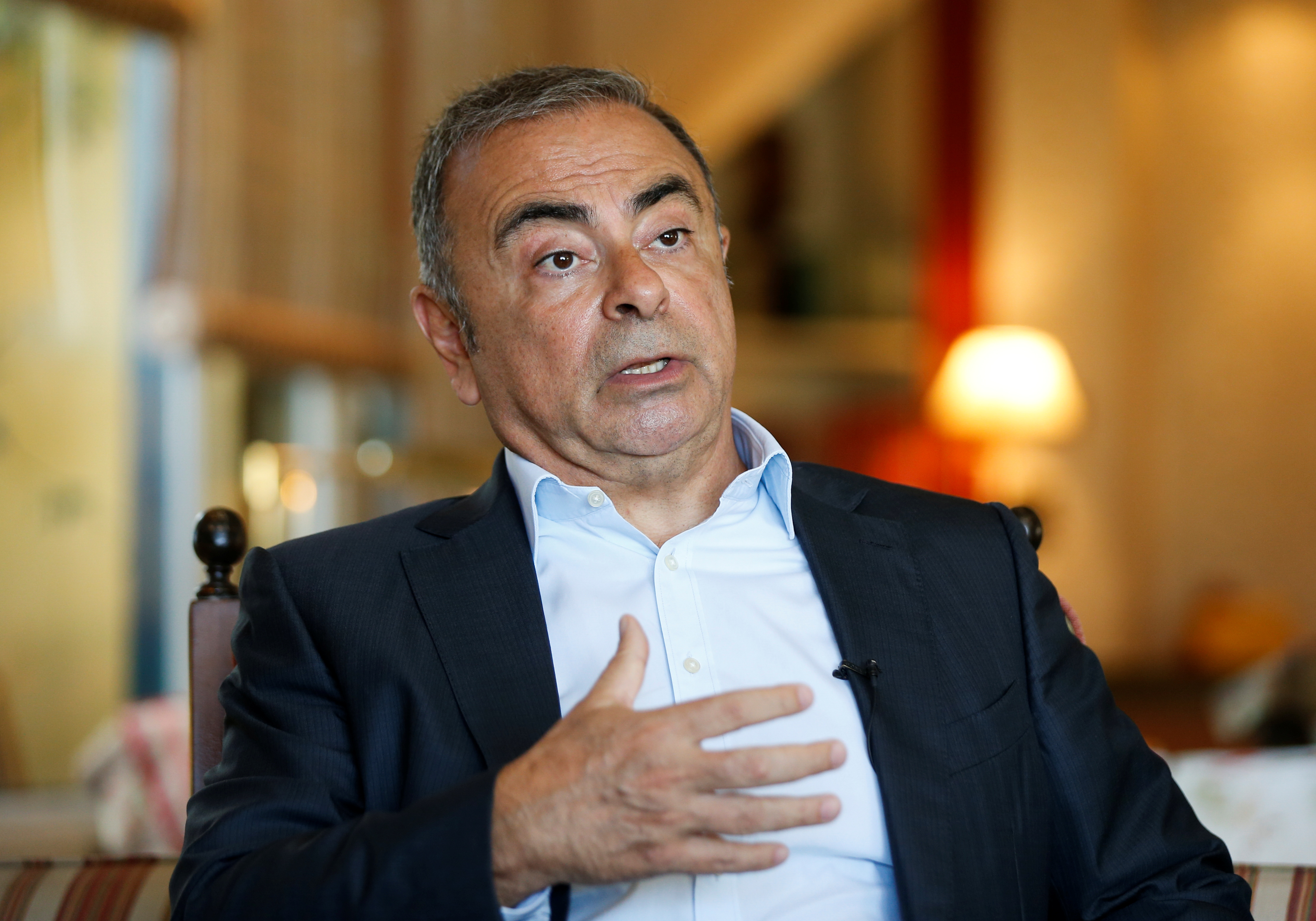 Fugitive former car executive Carlos Ghosn, gestures as he talks during an interview with Reuters in Beirut