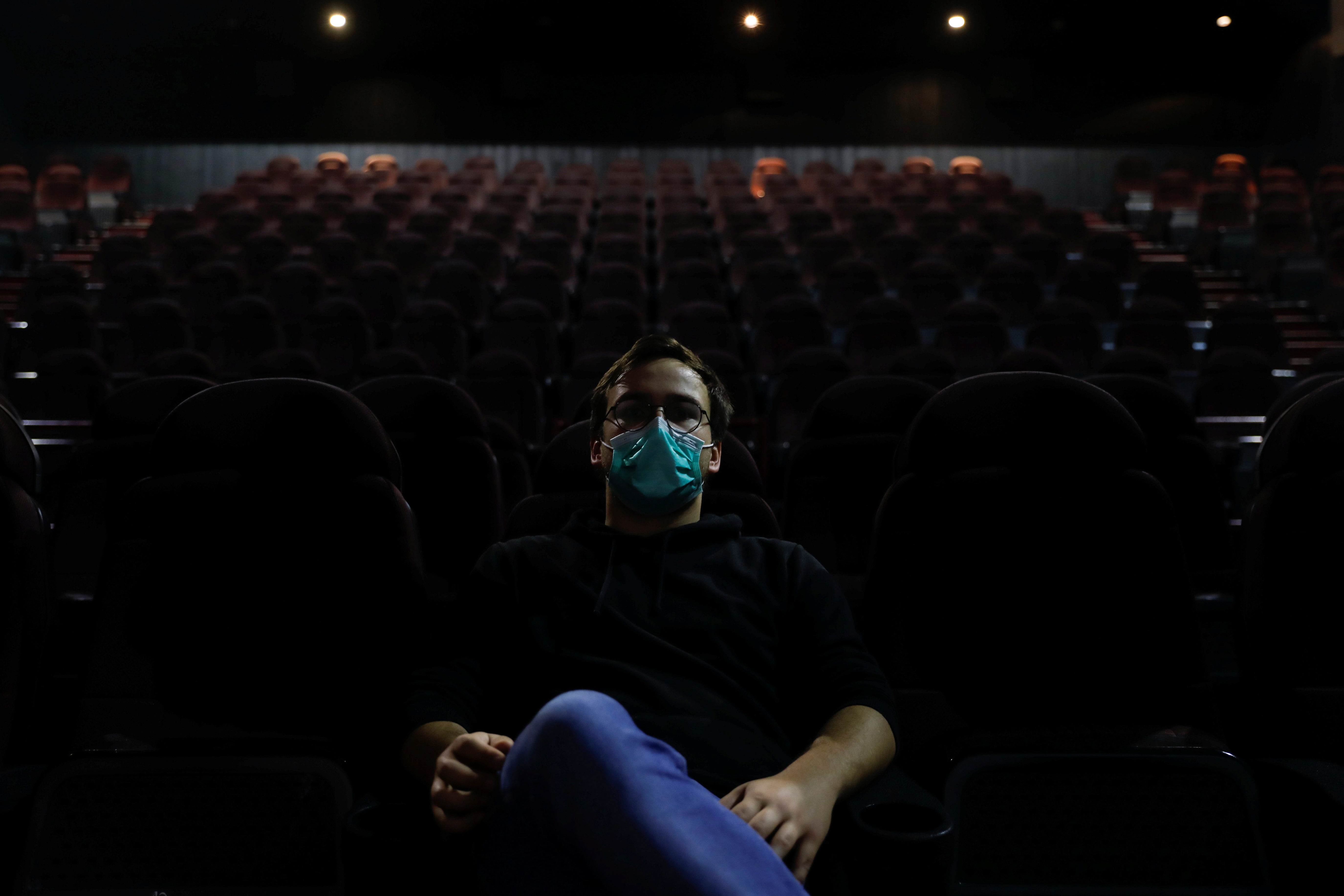 Diogo watches a movie on the first day of the opening of cinema theatres, in Sintra