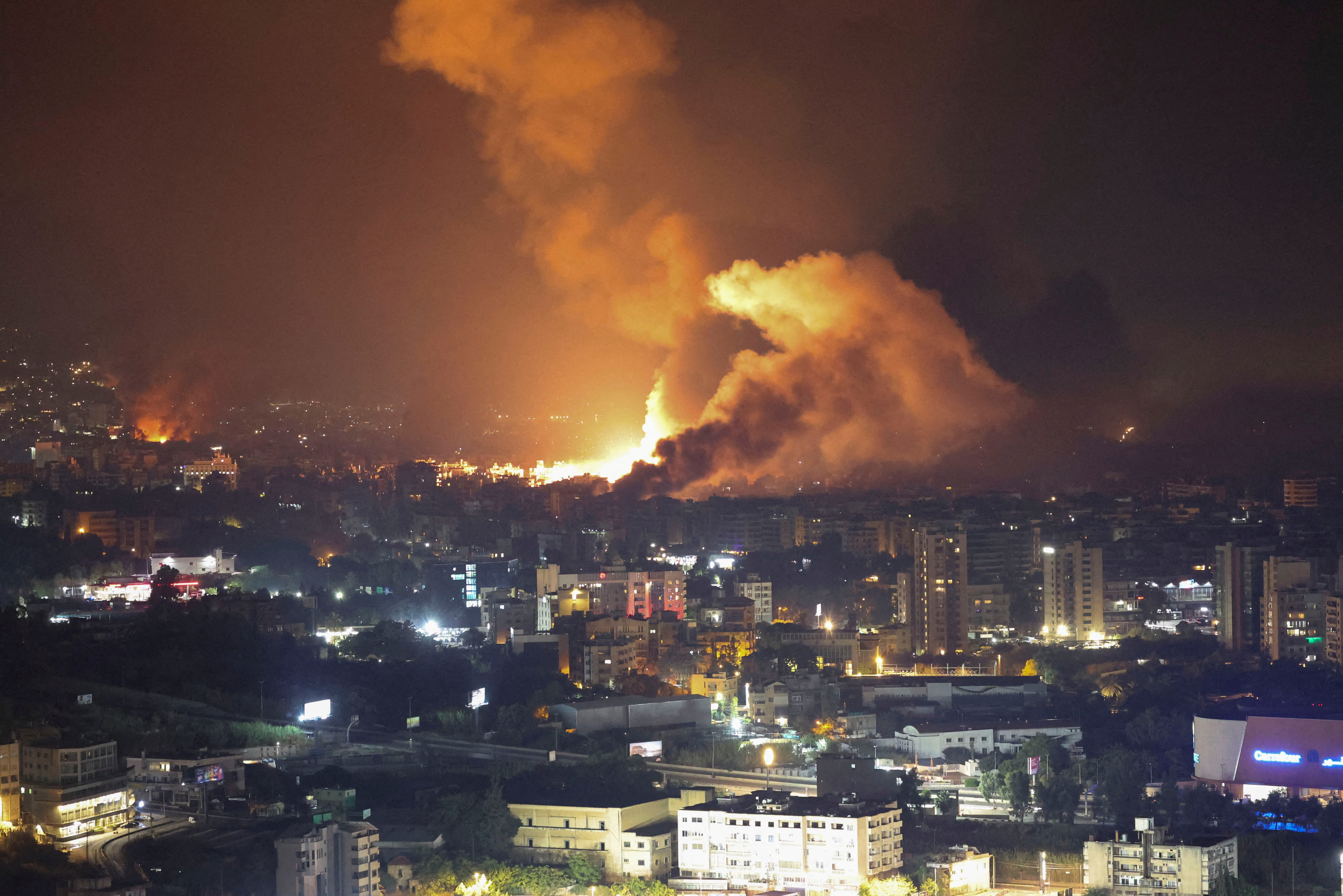 Smoke billows over Beirut's southern suburbs, as seen from Sin El Fil