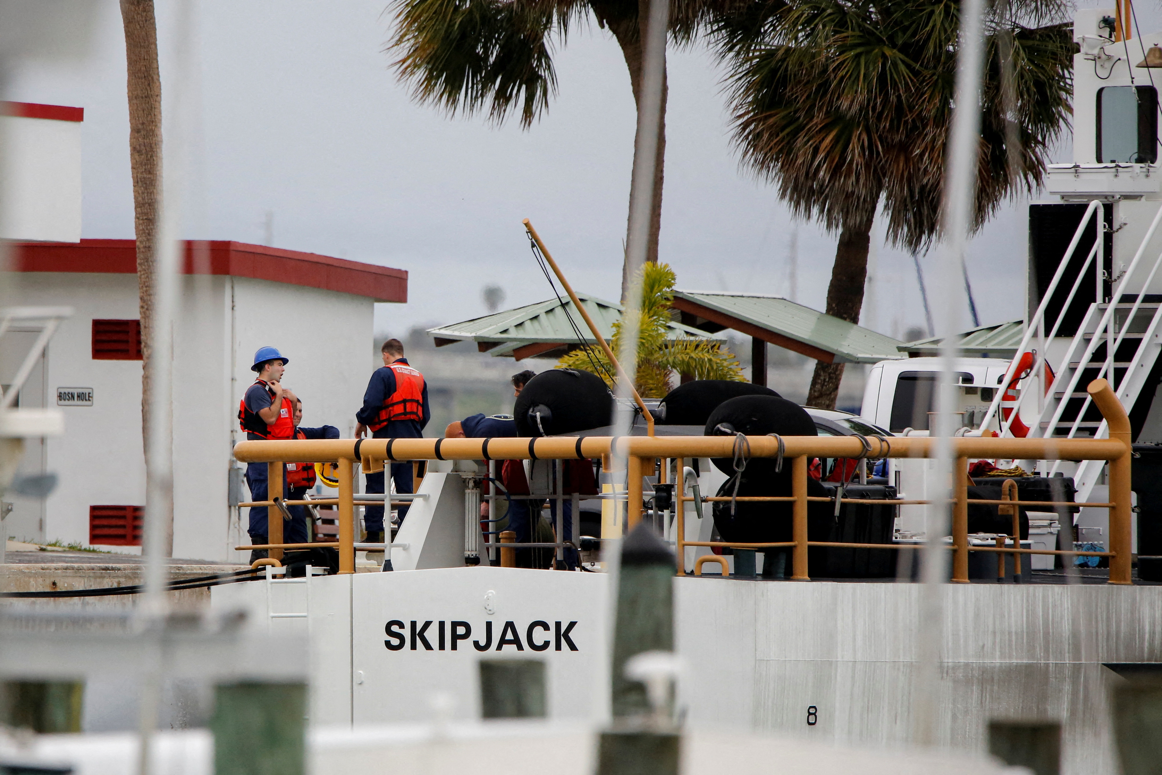 Members of the crew are seen onboard the U.S. Coast Guard Cutter Skipjack docked at the U.S. Coast Guard station, in Fort Pierce