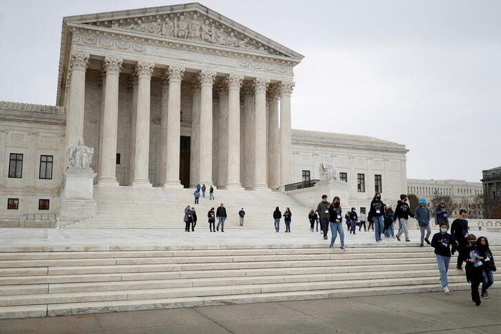 Visitors walk along Supreme Court Plaza on Capitol Hill in Washington