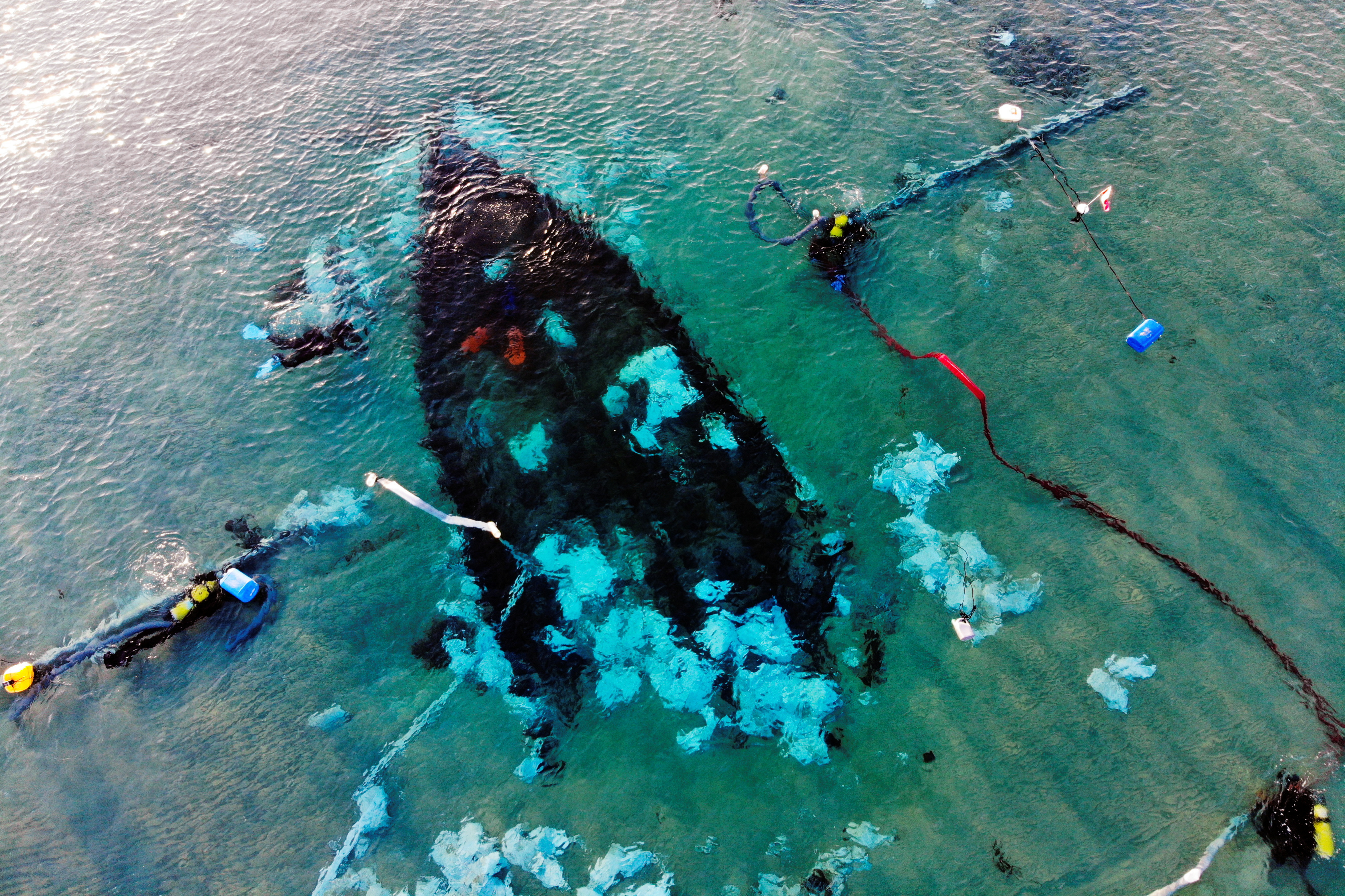 An aerial view shows the excavation of an ancient cargo ship, which is believed to have carried goods from all over the Mediterranean