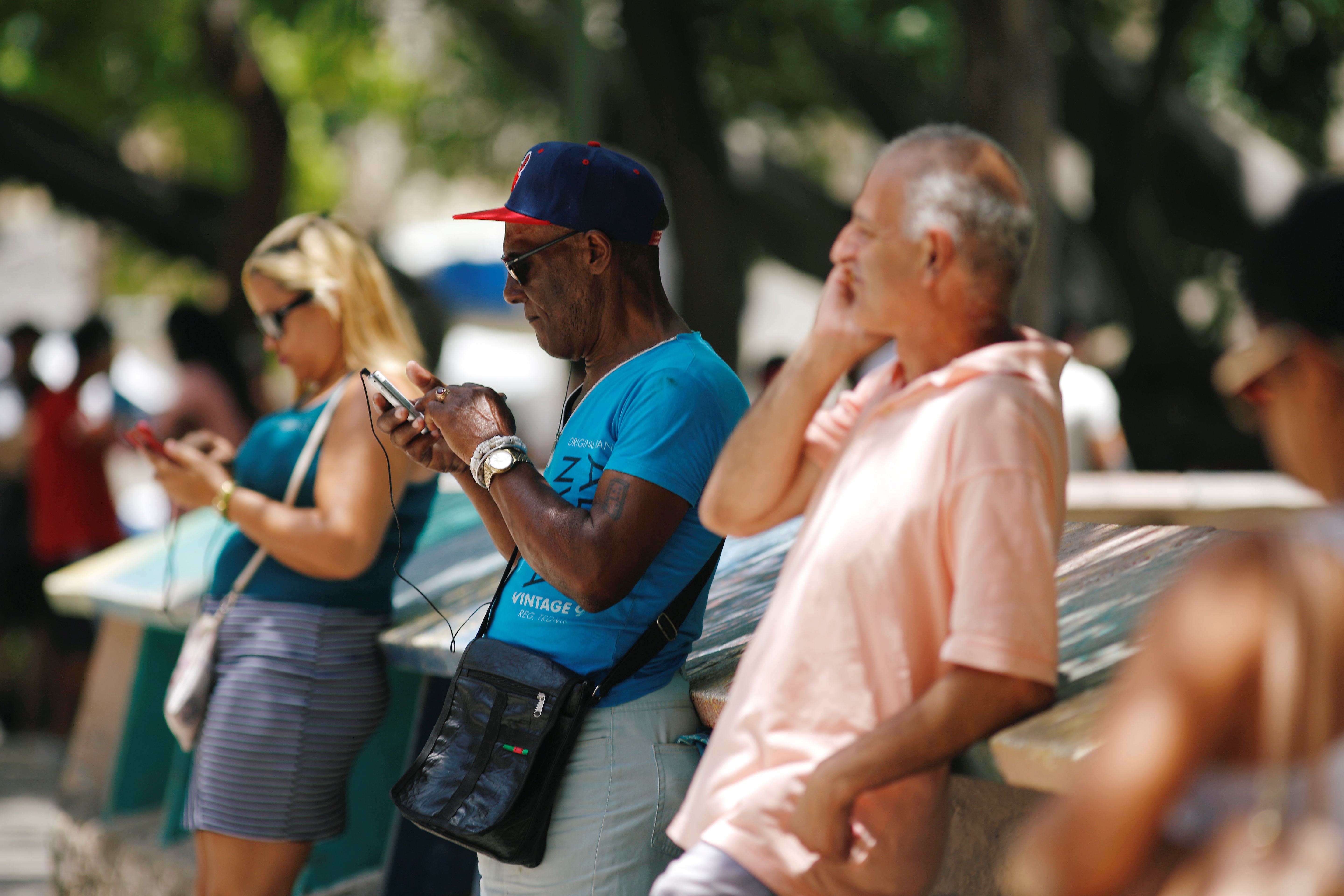 Cubans check their phones at an internet hotspot in Havana