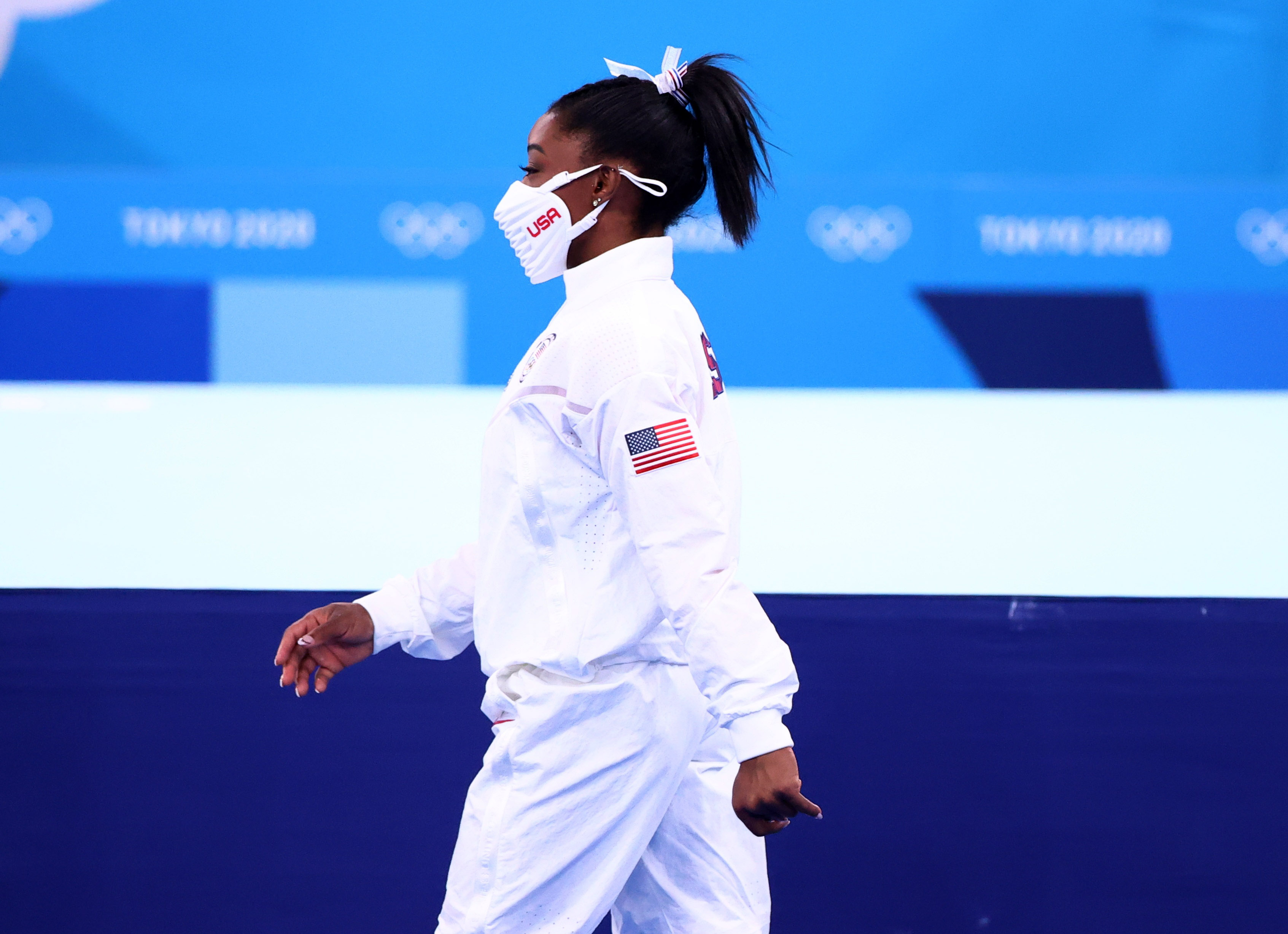 Tokyo 2020 Olympics - Gymnastics - Artistic - Women's Team - Final - Ariake Gymnastics Centre, Tokyo, Japan - July 27, 2021.  Silver medallist Simone Biles of the United States wearing a protective face mask walks. REUTERS/Lindsey Wasson