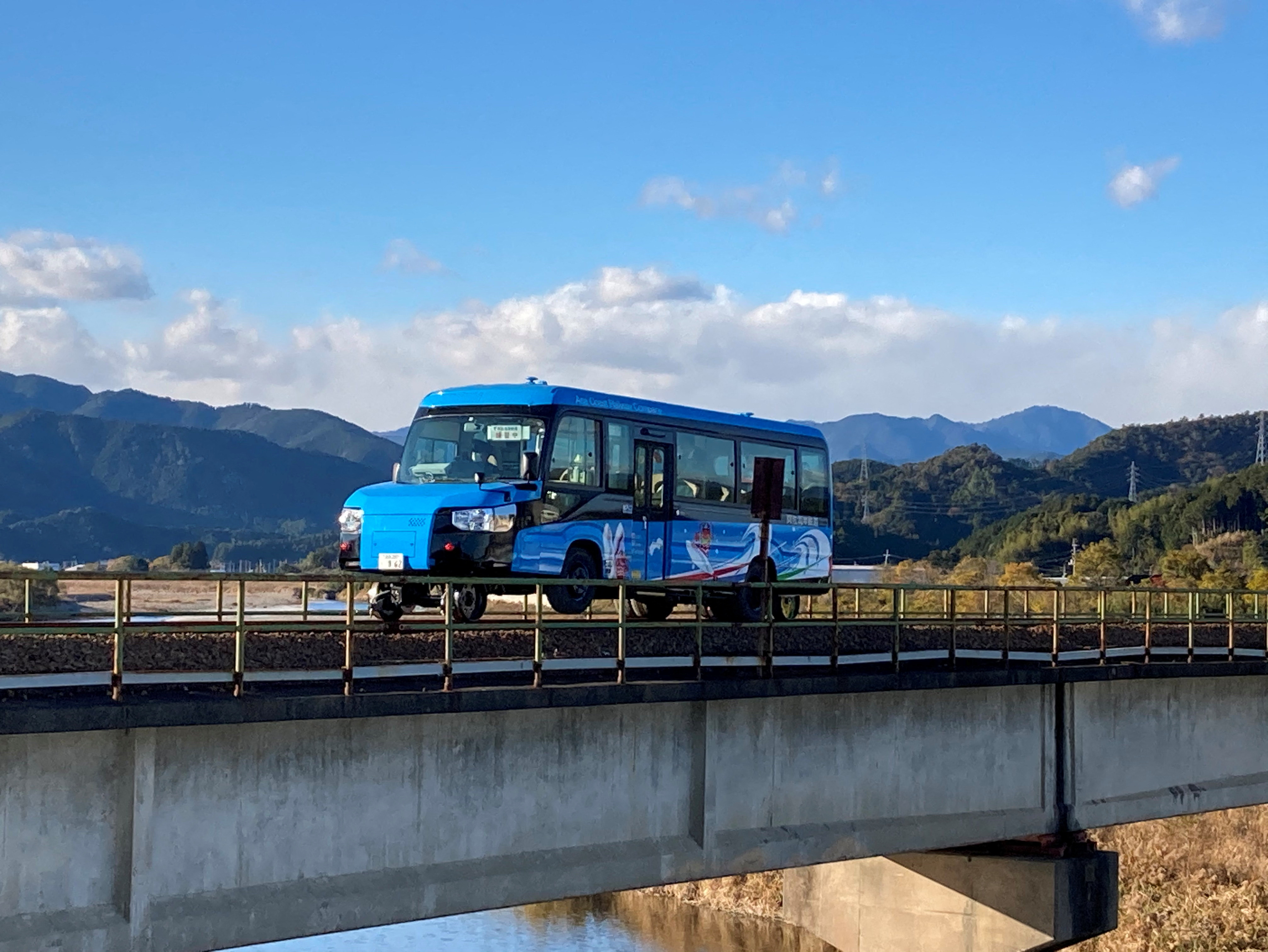 A 'Dual-Mode Vehicle (DMV)' bus that can run both on conventional road surfaces and a railway track, is seen during its test run in Kaiyo Town, Tokushima Prefectue, Japan, in this handout photo taken in December 2021 and released by Tokushima Prefectural Government, obtained by Reuters on December 24, 2021. Tokushima Prefectural Government/Handout via REUTERS  