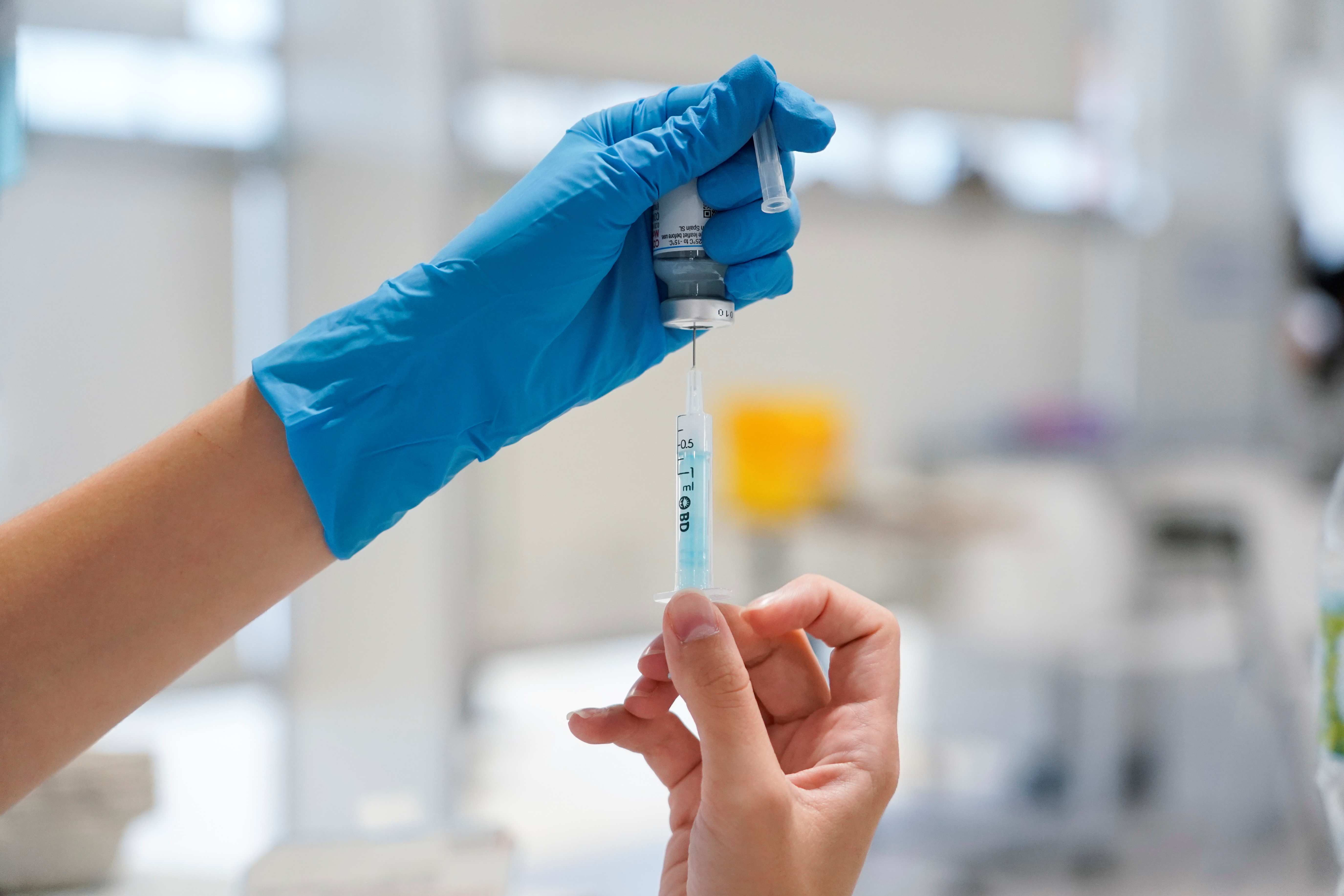 A nurse prepares a syringe with a dose of the Moderna coronavirus disease (COVID-19) vaccine at Enfermera Isabel Zendal hospital in Madrid, Spain, July 23, 2021. REUTERS/Juan Medina