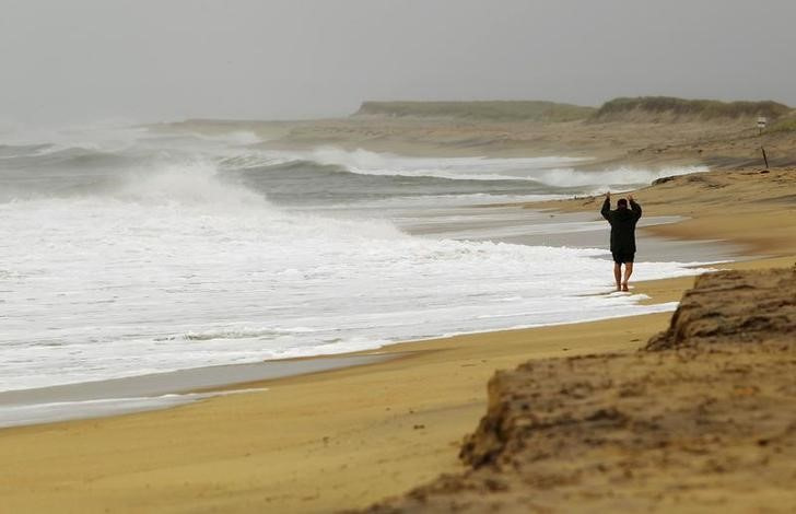 A man walks on the beach in Katama during a storm in the Northeast