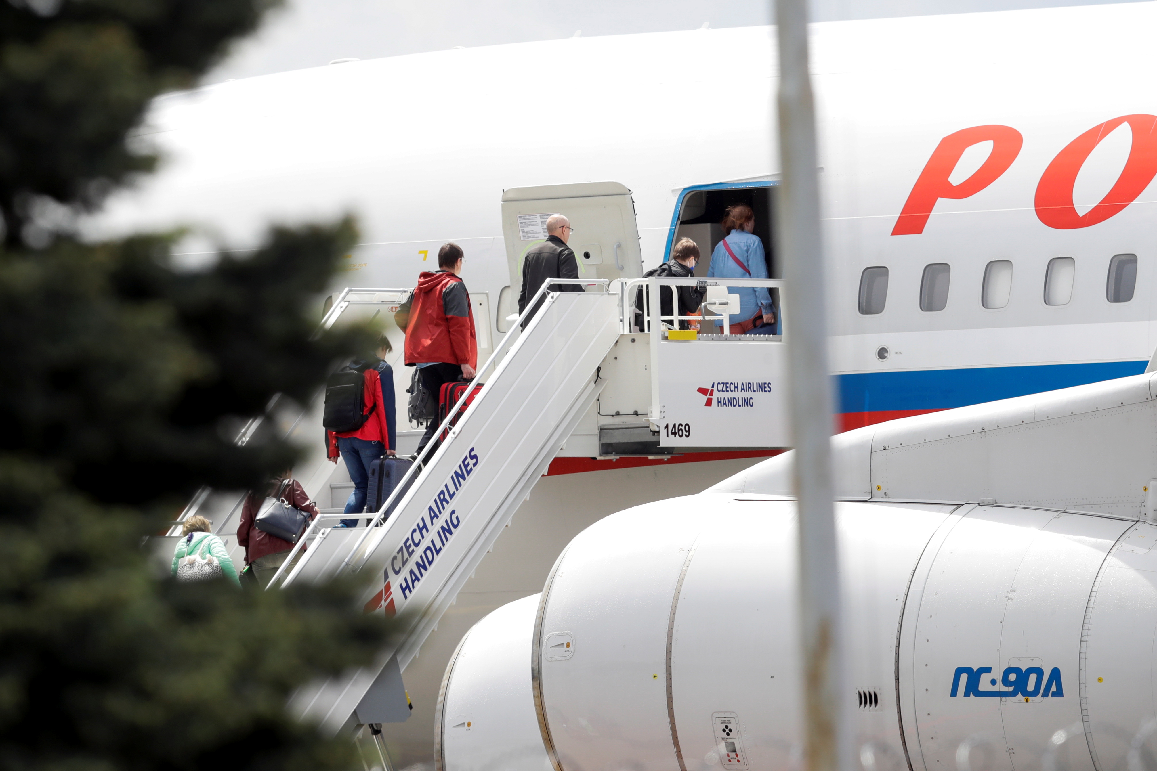 Passengers board a Russian government plane in Prague
