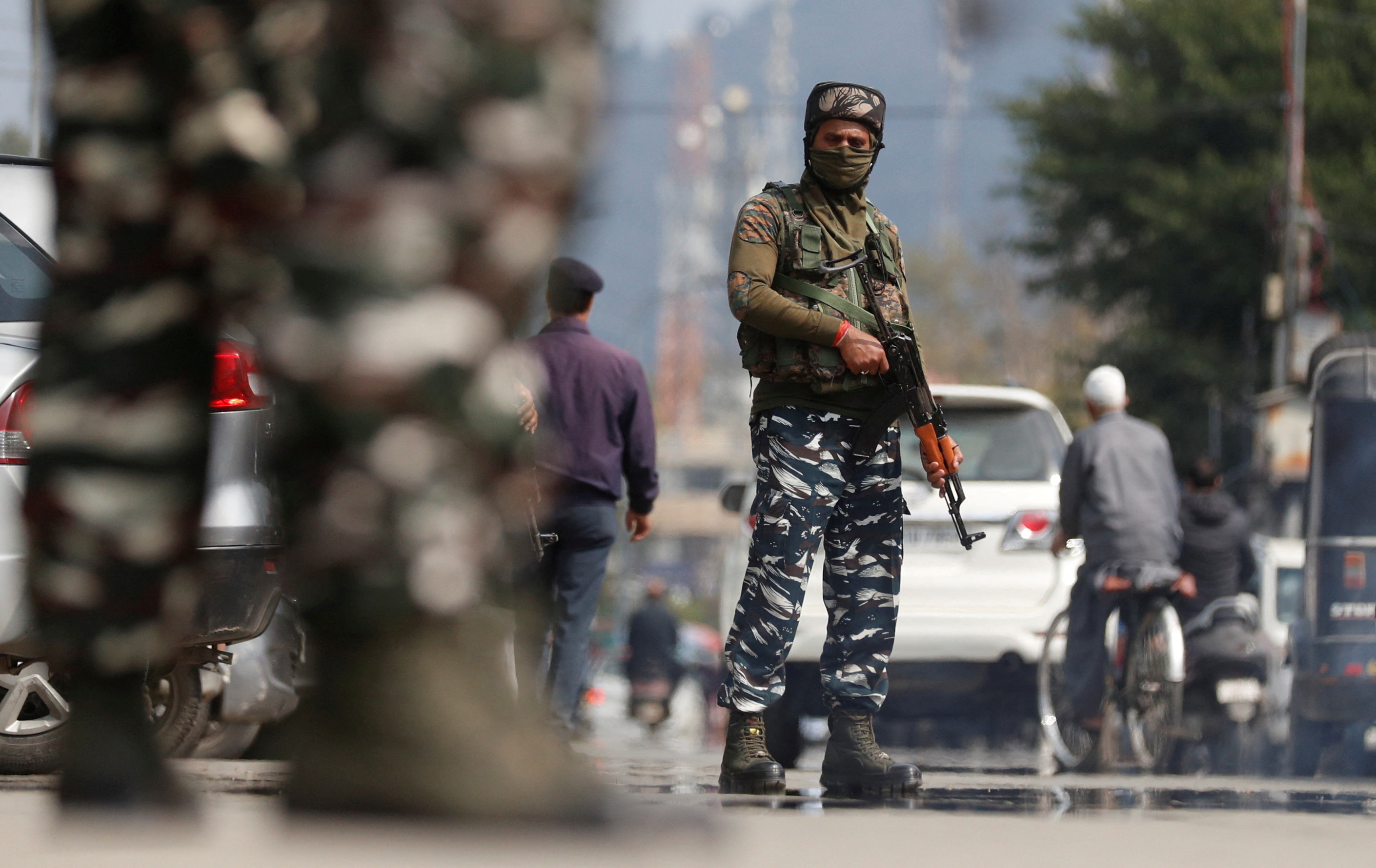 Indian Central Reserve Police Force personnel stand guard on a street, in Srinagar