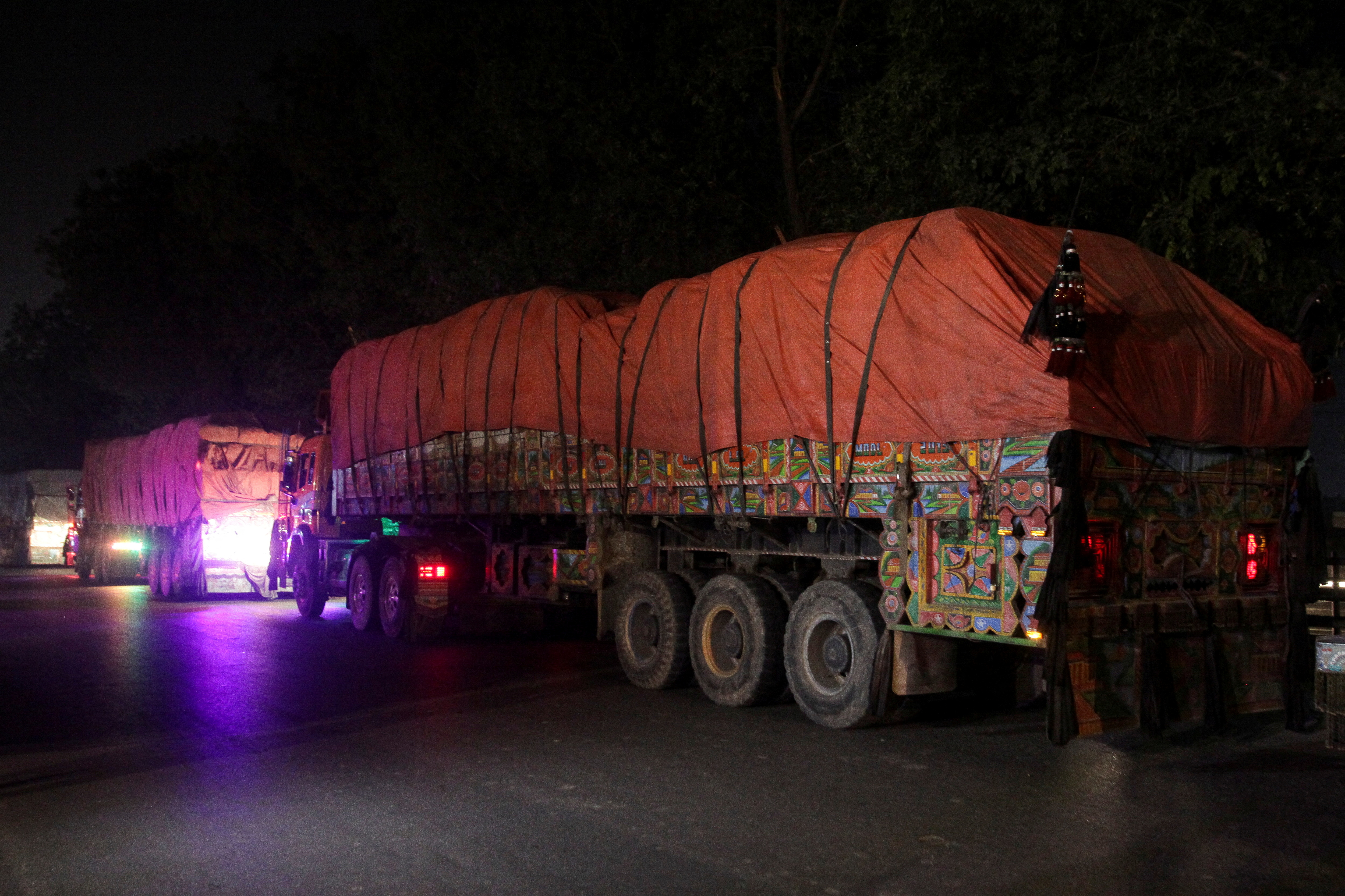 Supply trucks carrying aid shipments containing wheat to Afghanistan, move in a convoy near Lahore,