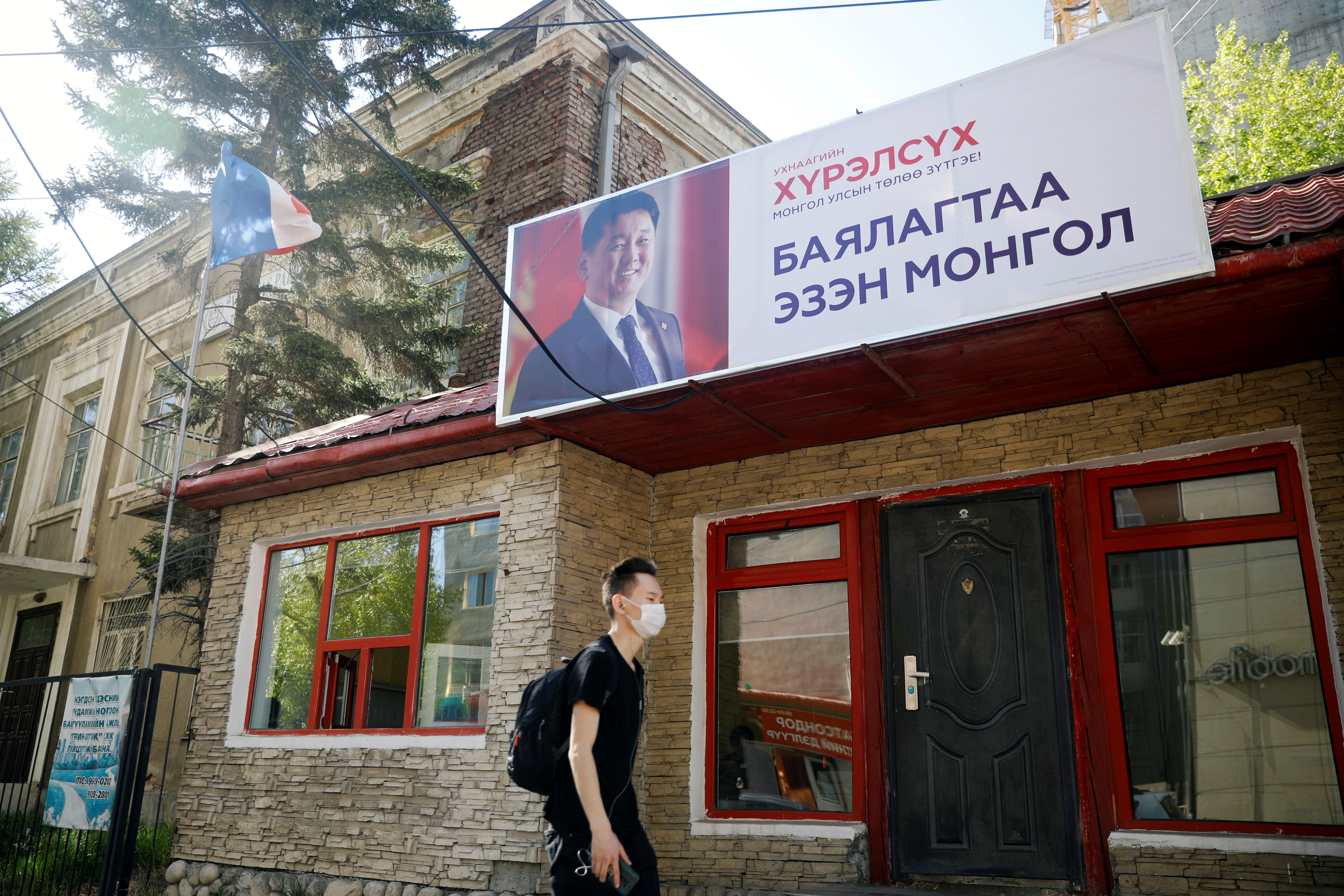 Man walks past campaign office for Ukhnaa Khurelsukh ahead of presidential election, in Ulaanbaatar