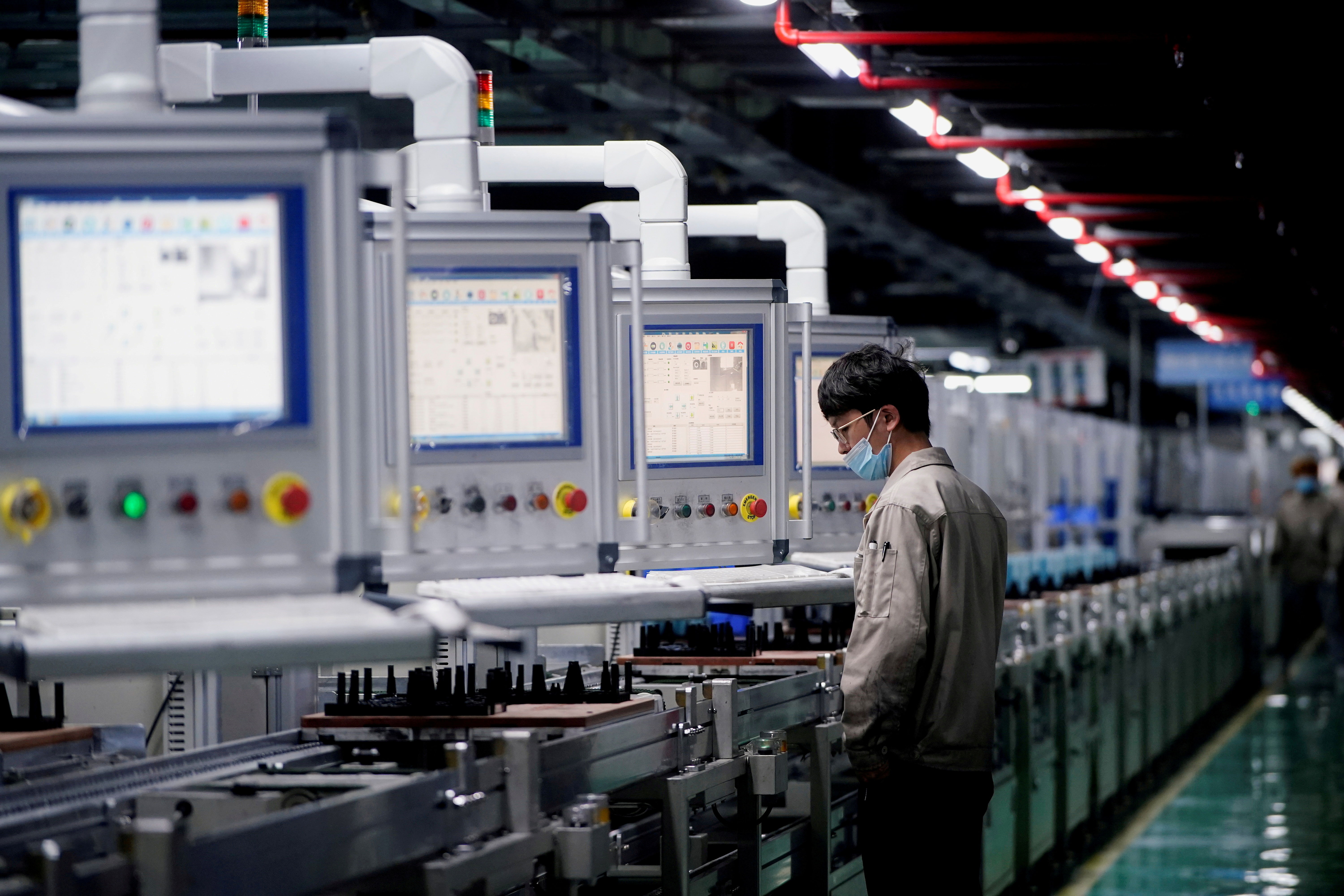 An employee works on the production line of electric vehicle (EV) battery manufacturer Octillion in Hefei
