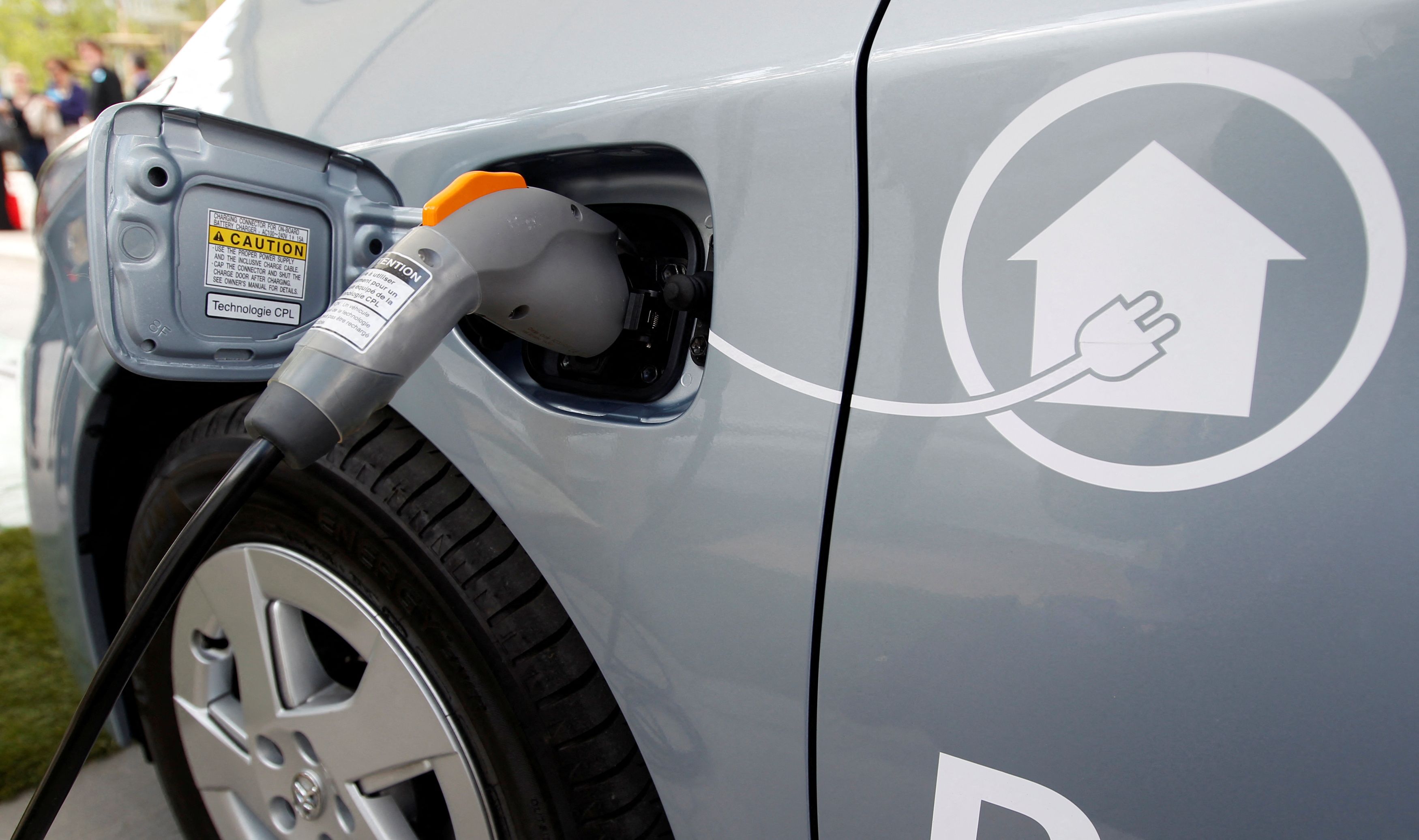 An electric wire is plugged into a Prius plugin hybrid car in Strasbourg