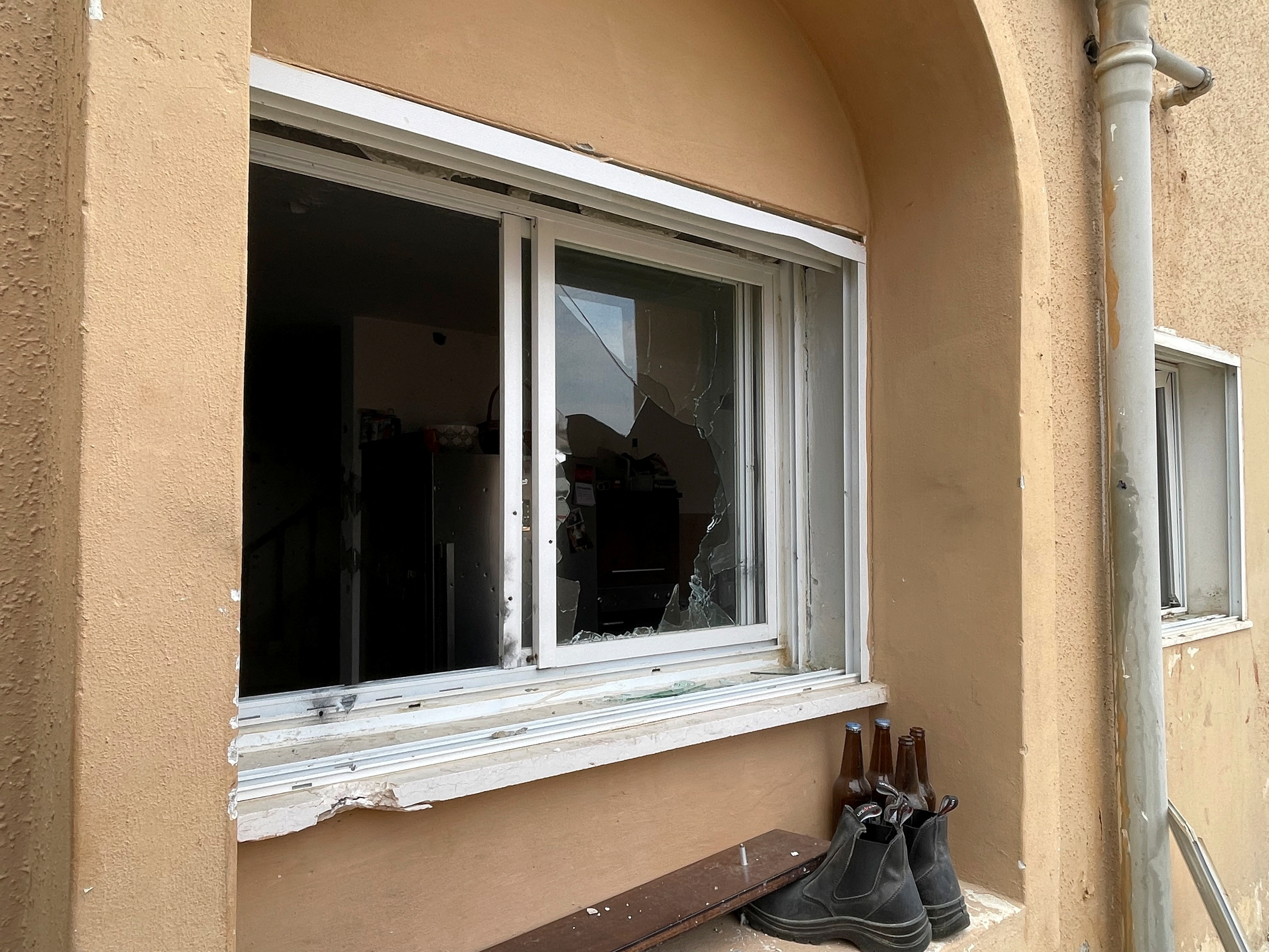 An image shows the broken window of a house that was held by Palestinian militants, as violence around the nearby Gaza Strip mounts following a mass-rampage by armed Palestinian infiltrators in Netivot, southern Israel