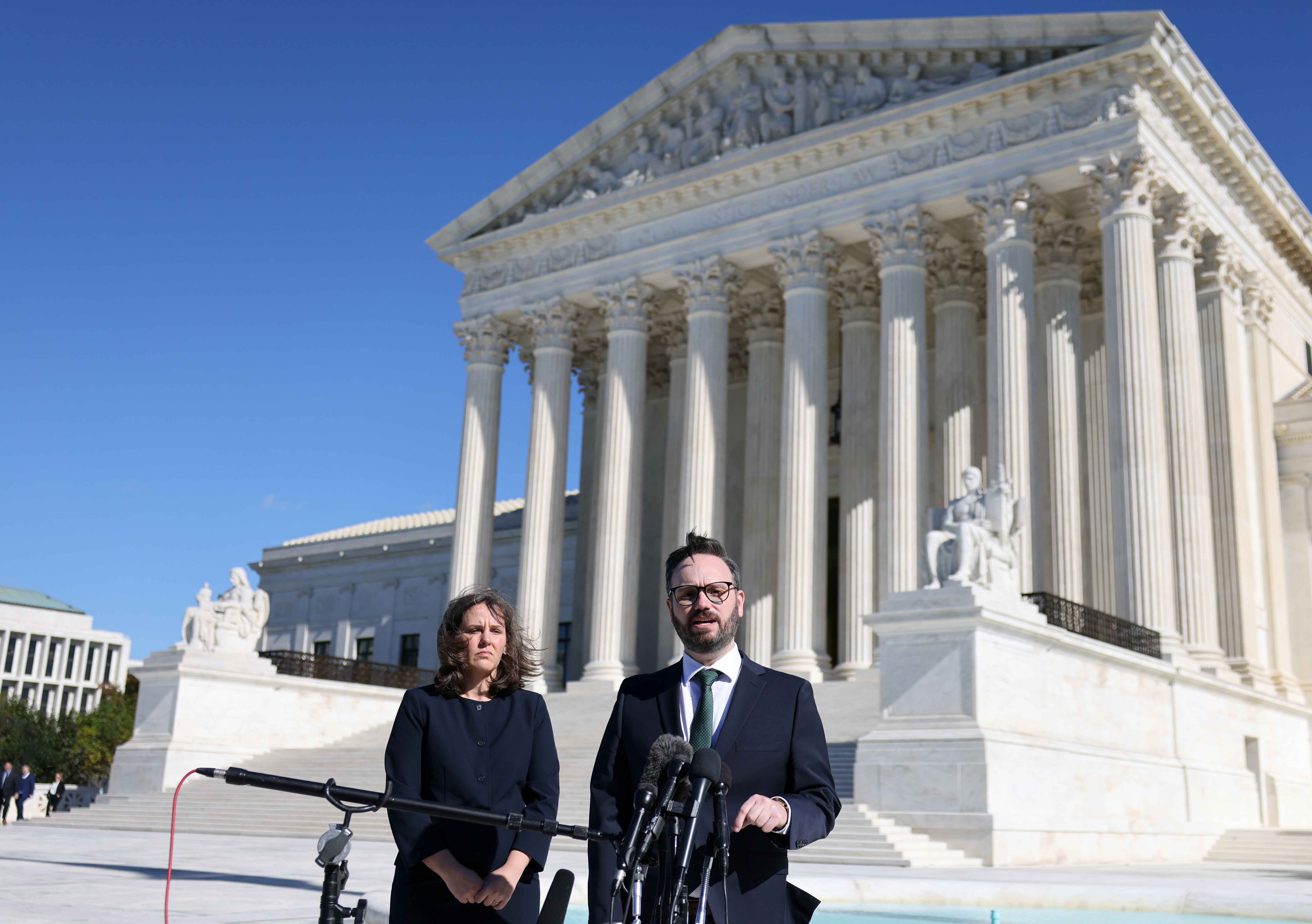 Attorney Marc Hearron with the Center for Reproductive Rights and attorney Julie Murray with Planned Parenthood, speak to the media following arguments over a challenge to a Texas law that bans abortion after six weeks, in front of the  United States Supreme Court in Washington, U.S., November 1, 2021. REUTERS/Evelyn Hockstein